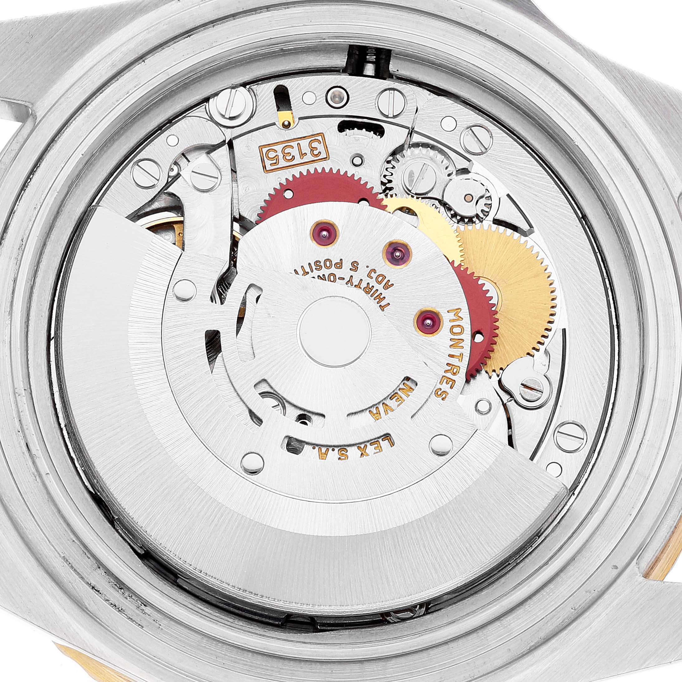 This image shows the open case back of a Rolex Submariner 16613 Men's Steel and Gold (two tone) Champagne Dial 16613 Men's Steel and Gold (two tone) Champagne Dial watch, revealing its intricate mechanical movement.