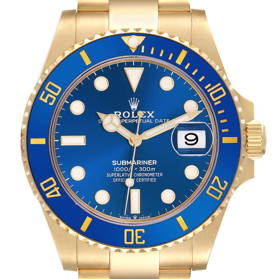 The Rolex Submariner is shown from a front angle, highlighting the blue dial, gold bezel, date window, and crown.