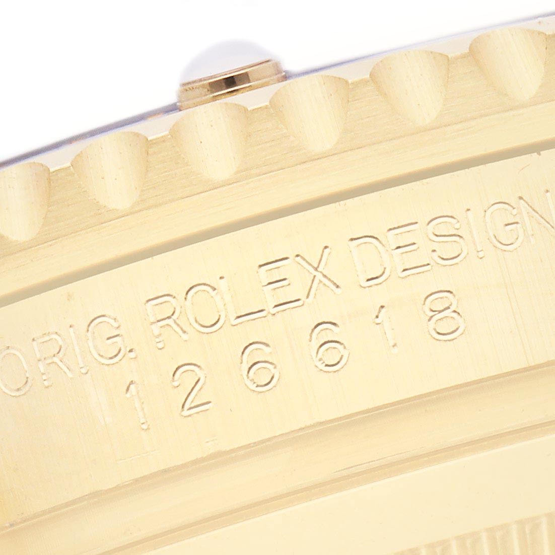 The image shows a close-up of the engraved side of a Rolex Submariner 126618LB Men's Yellow Gold Blue Dial 126618LB Men's Yellow Gold Blue Dial, focusing on the model number and part of the bezel.