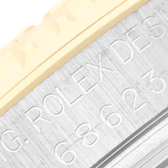 This image displays an angled close-up of the engraved side of the bezel and case of a Rolex Yacht-Master 68623 Men's Steel and Gold (two tone) White Dial 68623 Men's Steel and Gold (two tone) White Dial watch.