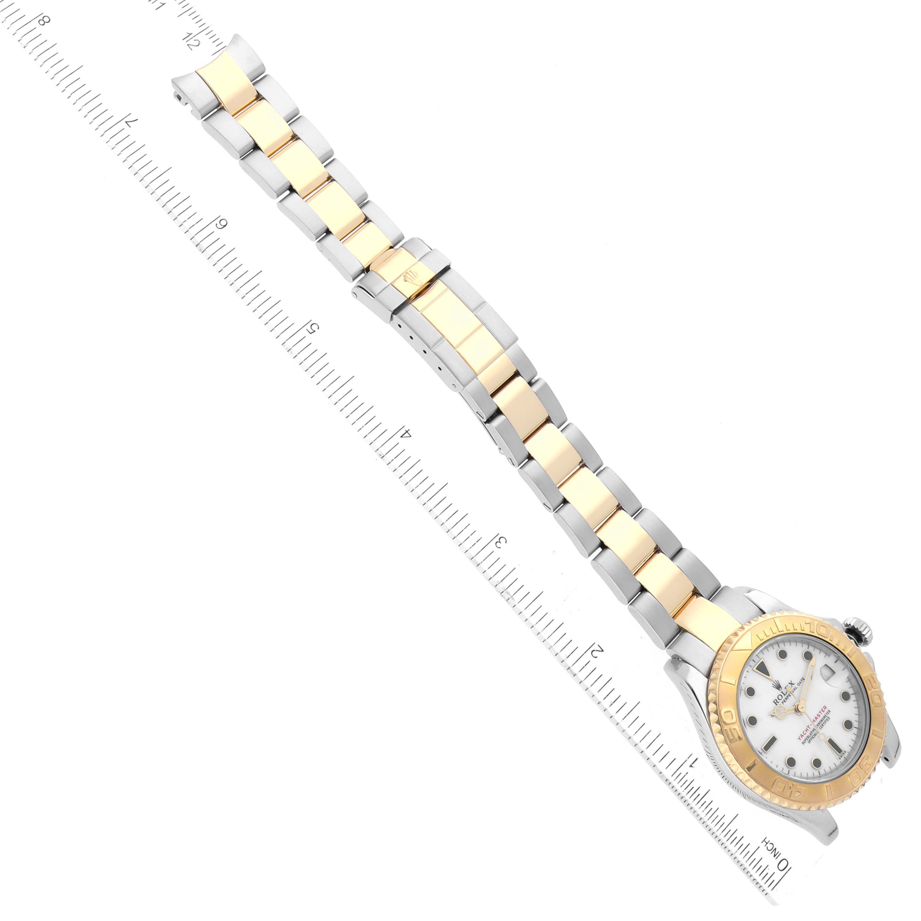 The image shows a Rolex Yacht-Master 68623 Men's Steel and Gold (two tone) White Dial 68623 Men's Steel and Gold (two tone) White Dial watch laid flat with its bracelet and case clearly visible, alongside a ruler for scale.