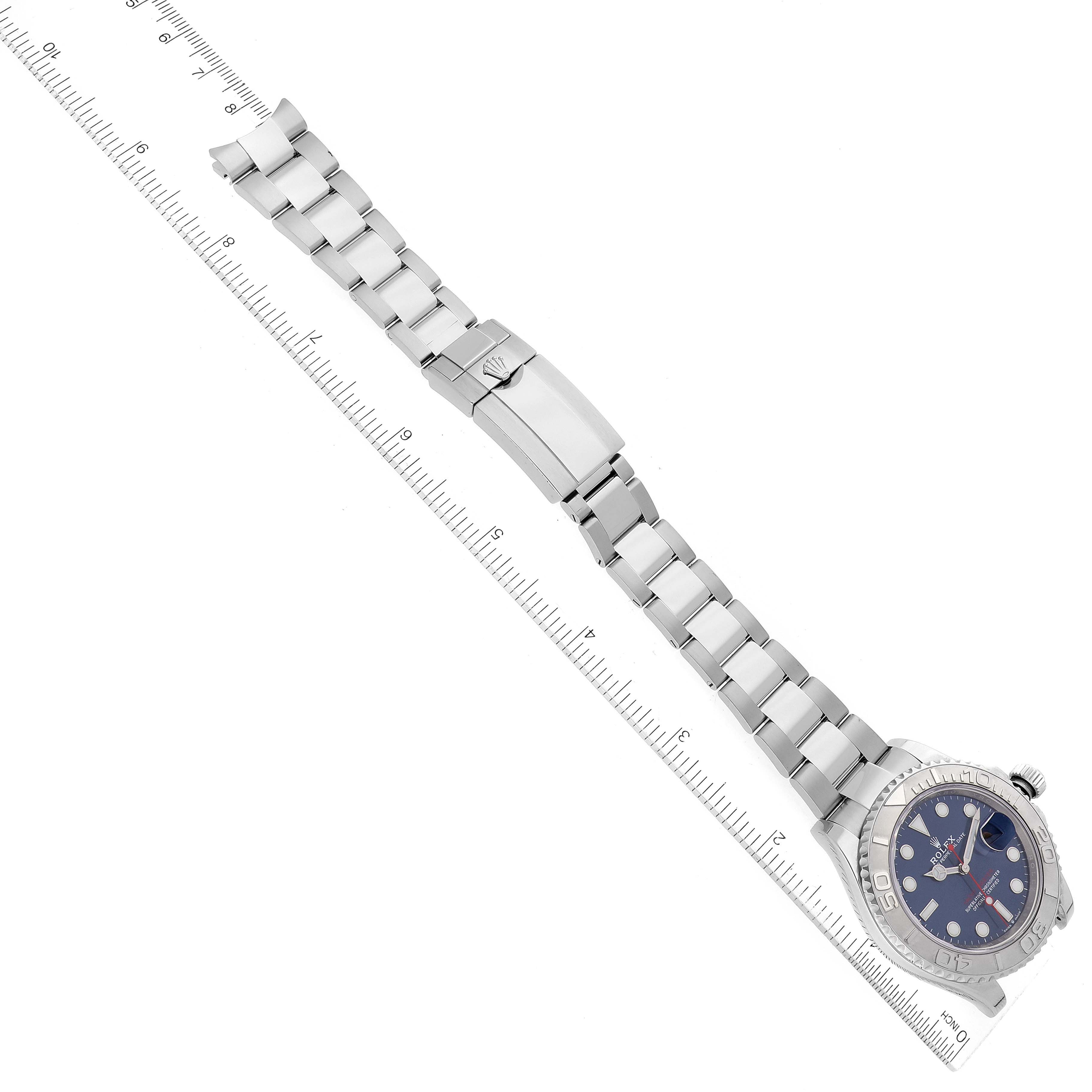 The Rolex Yacht-Master 126622 Men's Stainless Steel Blue Dial 126622 Men's Stainless Steel Blue Dial watch is displayed flat, highlighting its full bracelet, clasp, and dial, with a ruler for scale.