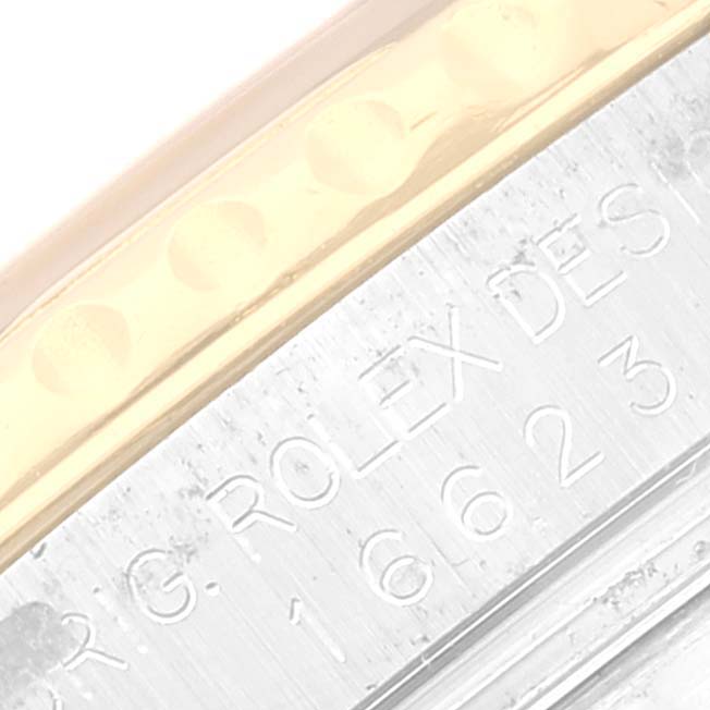 This close-up image shows the engraved side of the Rolex Yacht-Master 16623 Men's Steel and Gold (two tone) White Dial 16623 Men's Steel and Gold (two tone) White Dial's case and part of the gold bezel.