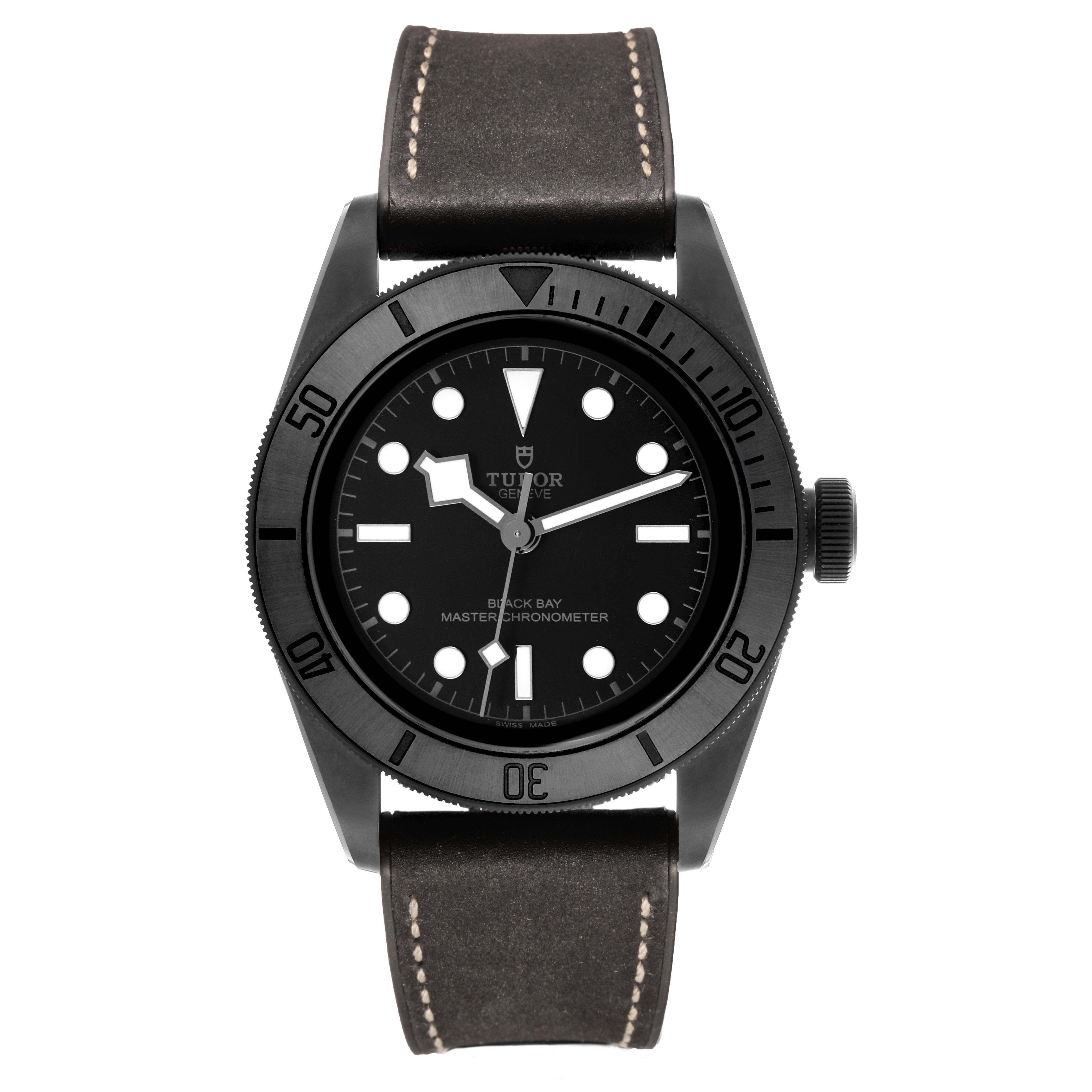 The Tudor Heritage Black Bay 79210 Men's Ceramic Black Dial watch is shown from a front angle, displaying its dial, bezel, and leather strap.