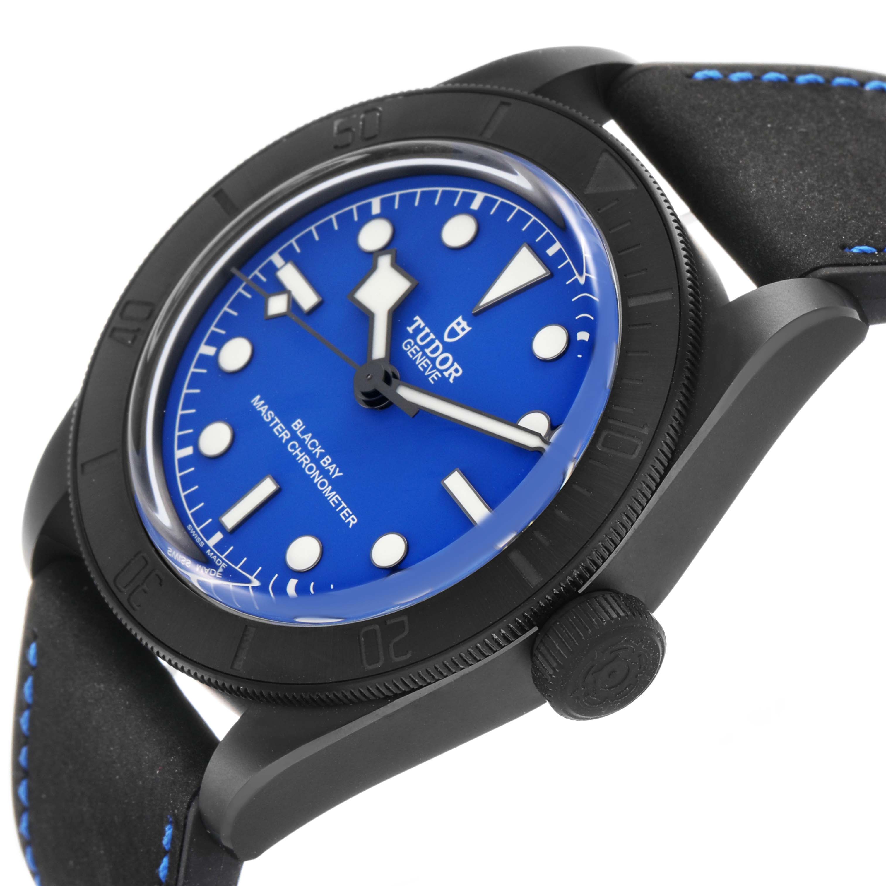 The Tudor Heritage Black Bay 79210 Men's Ceramic Blue Dial watch is shown at a slight side angle, highlighting the blue dial, bezel, and crown, with a partial view of the strap.