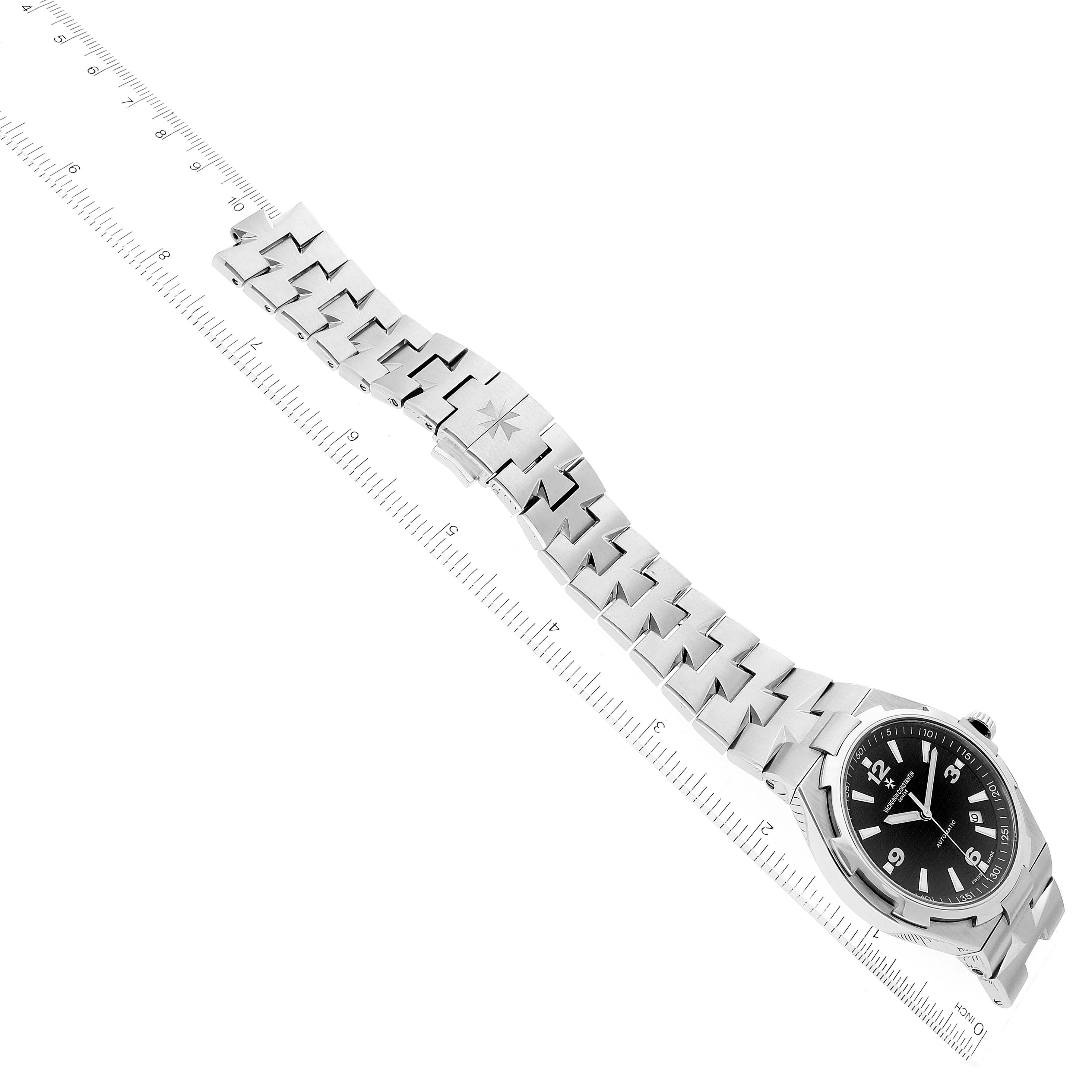 The image shows a side angle of a Vacheron Constantin Overseas 47040/B01A-9094 Men's Stainless Steel Black Dial 47040/B01A-9094 Men's Stainless Steel Black Dial watch, displaying its black dial and stainless steel bracelet.