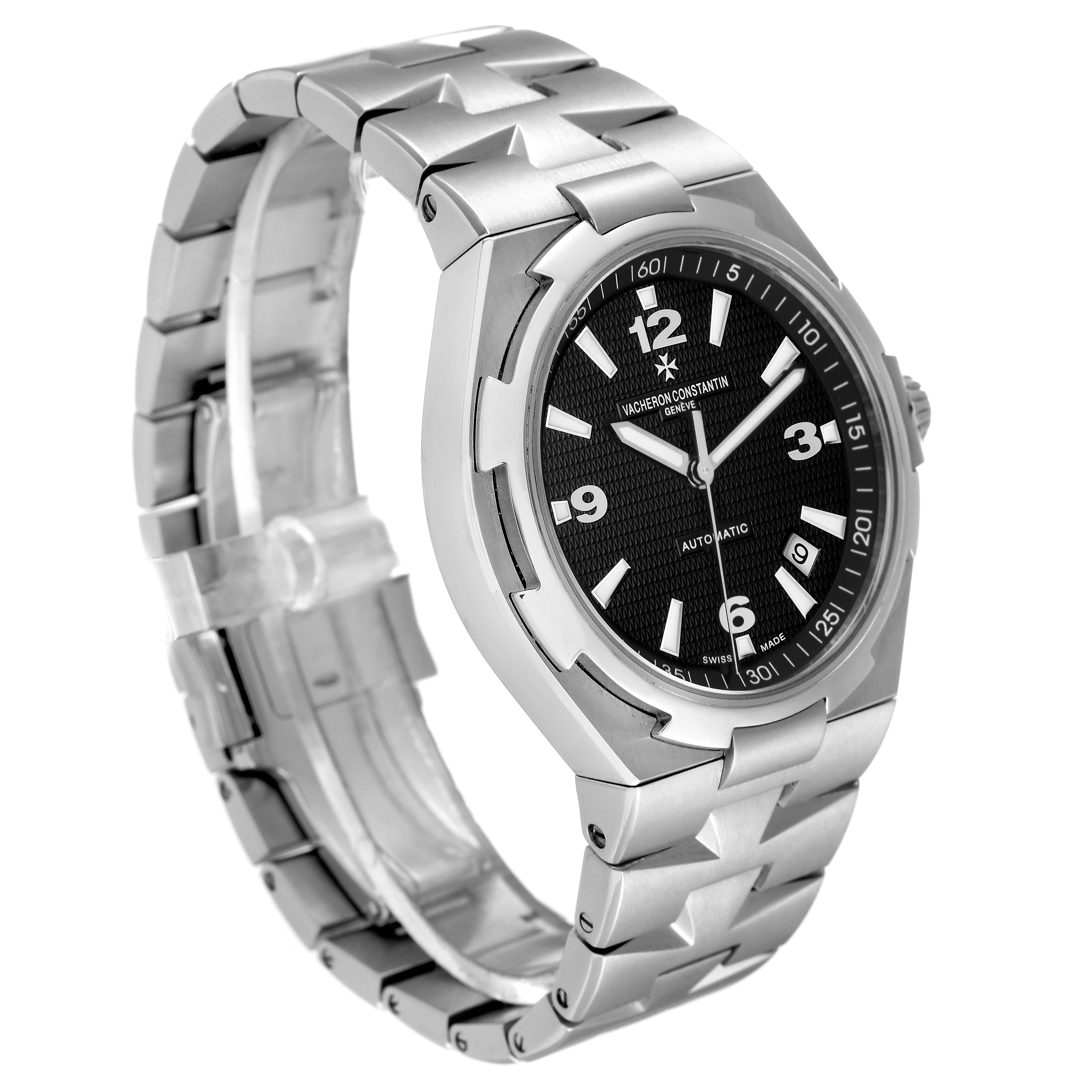 The Vacheron Constantin Overseas 47040/B01A-9094 Men's Stainless Steel Black Dial 47040/B01A-9094 Men's Stainless Steel Black Dial watch is shown at an angle highlighting the face, bezel, and metal bracelet.