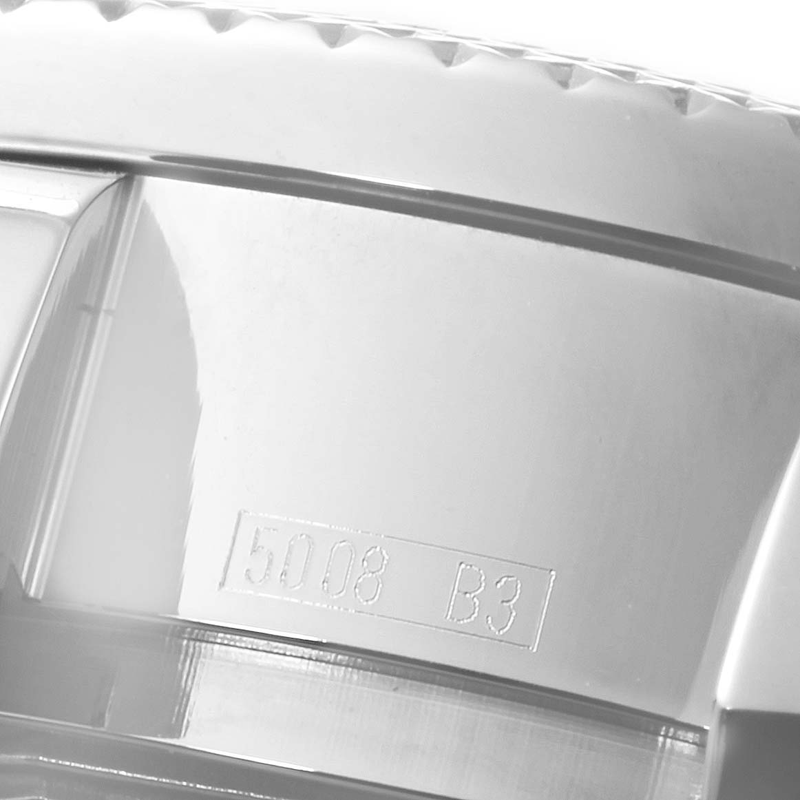 The image shows a close-up of the engraved bezel edge of a Bentley model Breitling watch.