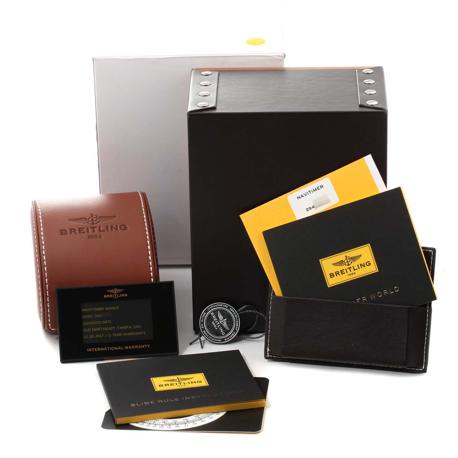 The image shows accessories for a Breitling Navitimer A24322 Men
s Stainless Steel Silver Dial A24322 Men
s Stainless Steel Silver Dial watch, including boxes, manuals, a warranty card, and a leather case.