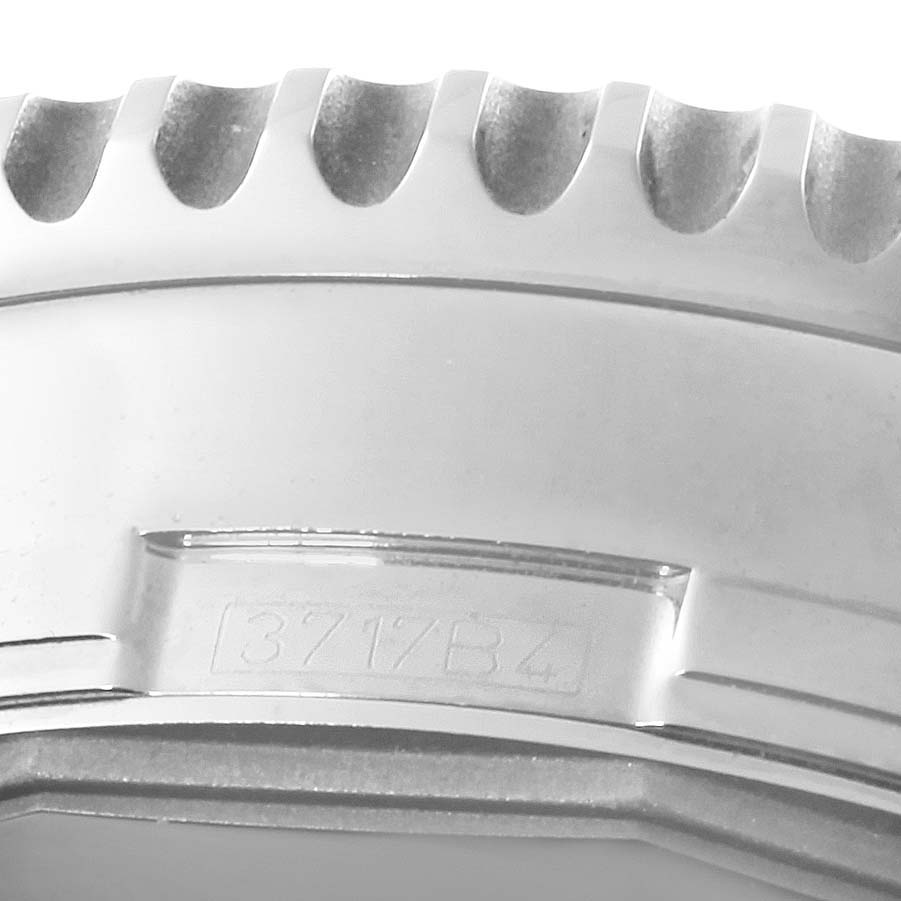This image shows a close-up of the ridged bezel and some markings on the case of a Breitling Navitimer A24322 Men
s Stainless Steel Silver Dial A24322 Men
s Stainless Steel Silver Dial watch.