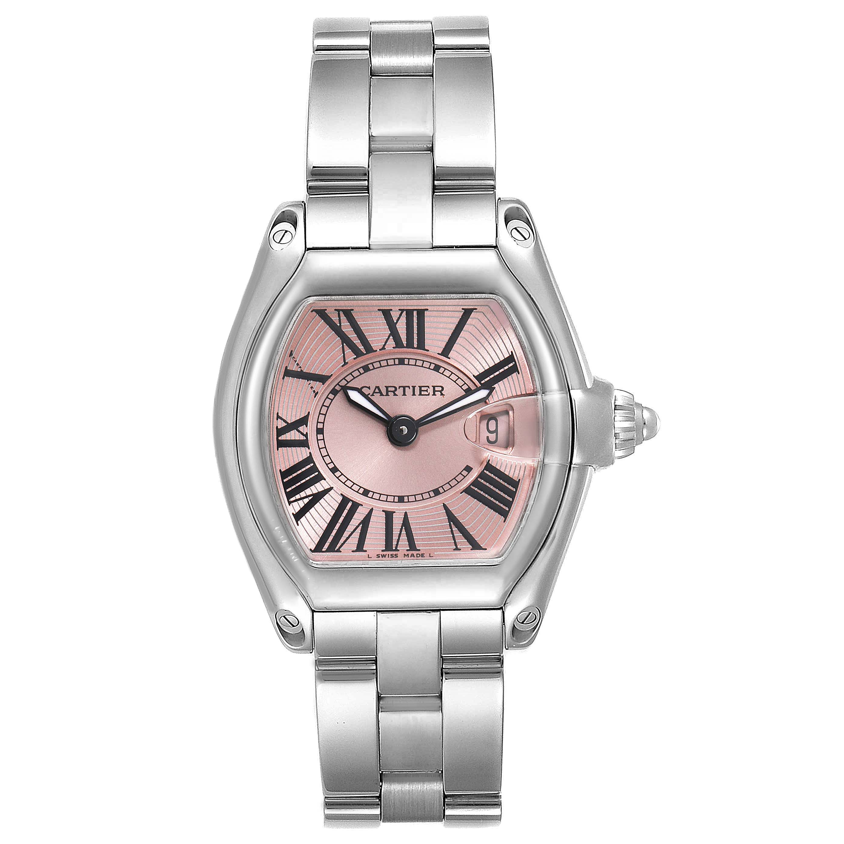The image shows a frontal view of the Cartier Roadster W62017V3 Women's Stainless Steel Pink Dial W62017V3 Women's Stainless Steel Pink Dial watch, highlighting its pink dial, Roman numerals, and metal bracelet.