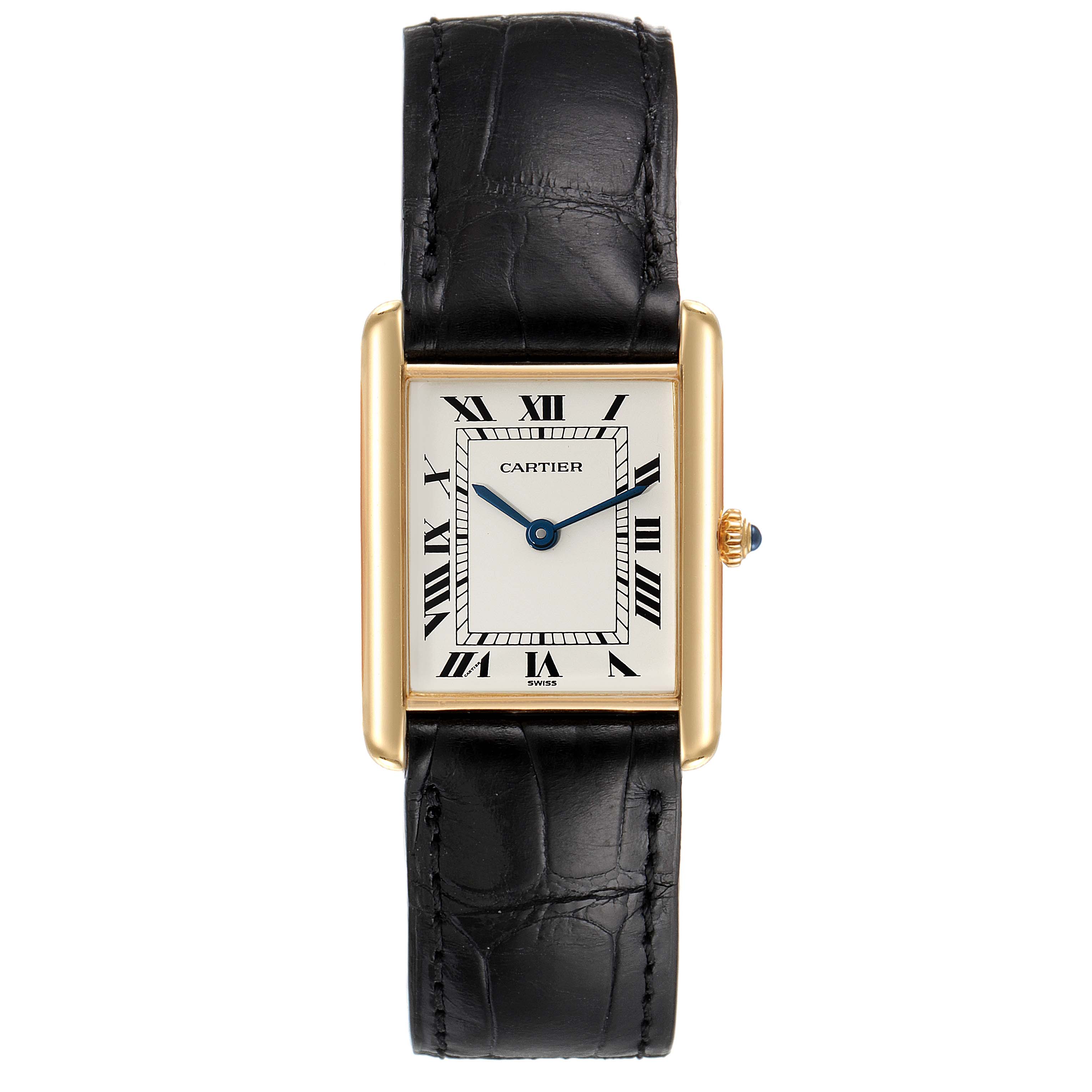 The Cartier Tank Classic Women's Yellow Gold White Dial Women's Yellow Gold White Dial watch is shown from a front angle, highlighting its rectangular face, black leather strap, and gold casing.
