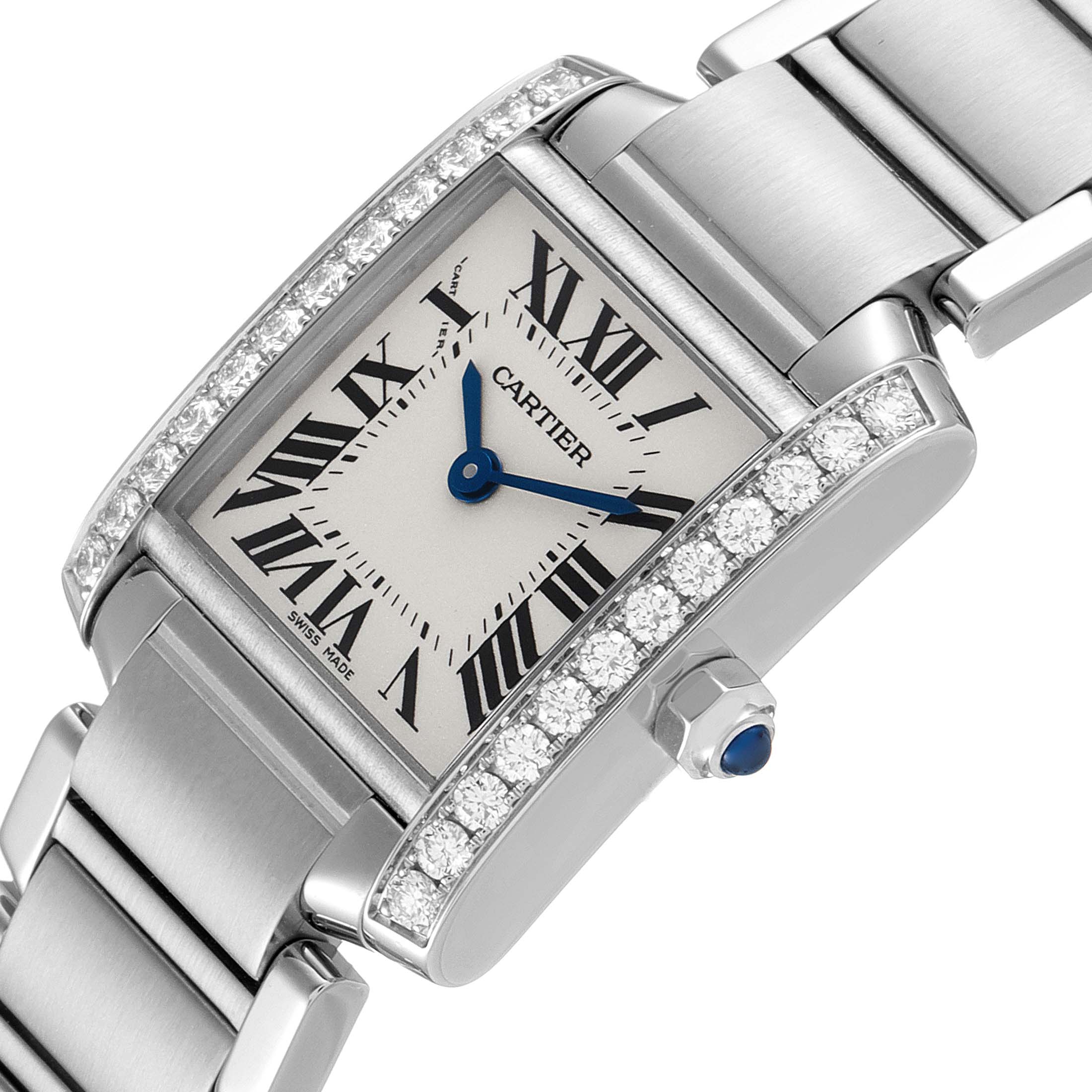 This is an angled view of the Cartier Tank Francaise W4TA0008 Women's Stainless Steel Silver Dial W4TA0008 Women's Stainless Steel Silver Dial watch showing the face, blue hands, Roman numerals, and diamond-encrusted bezel.