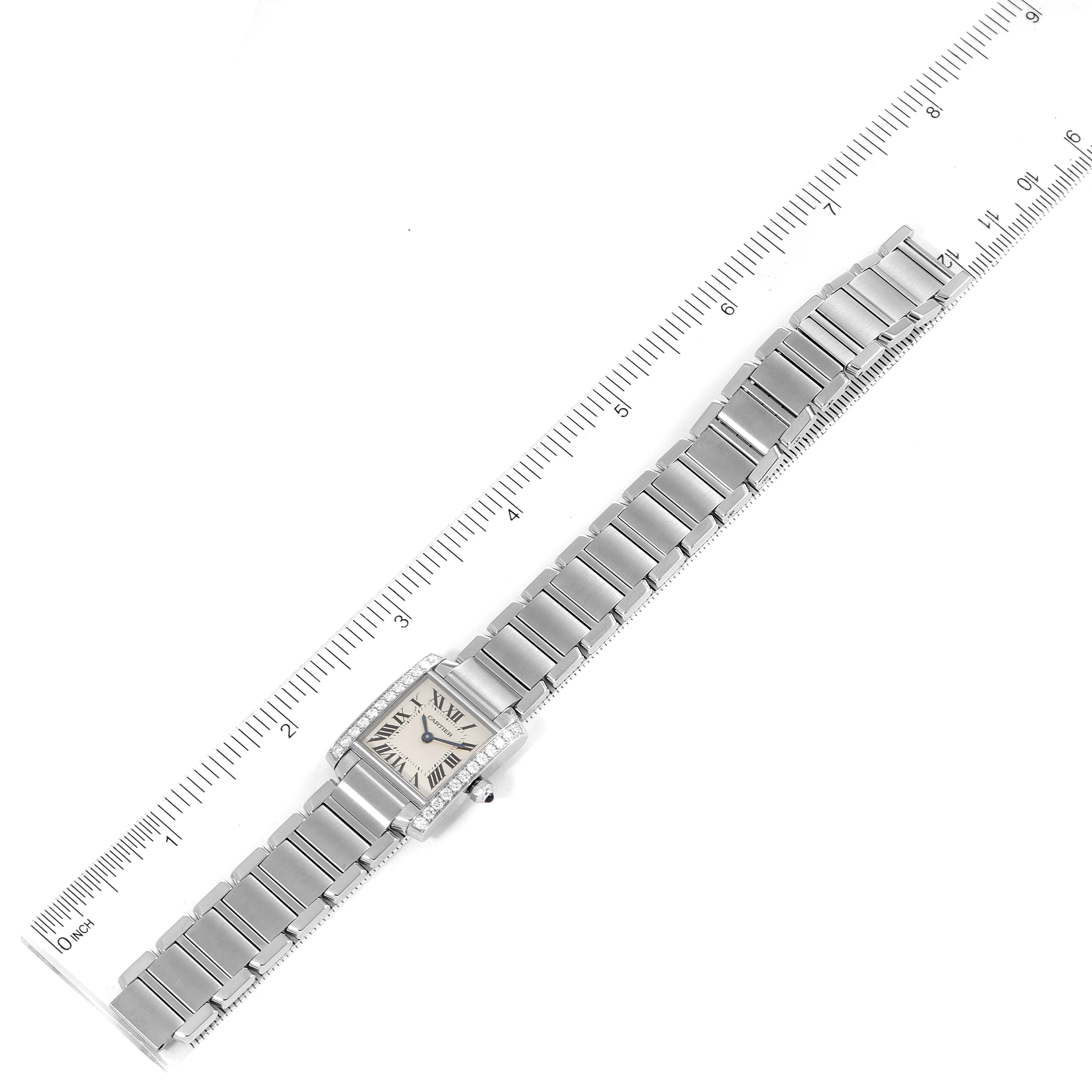 The image shows a Cartier Tank Francaise W4TA0008 Women's Stainless Steel Silver Dial W4TA0008 Women's Stainless Steel Silver Dial watch laid flat, revealing the face, bracelet, and some measurements using a ruler.