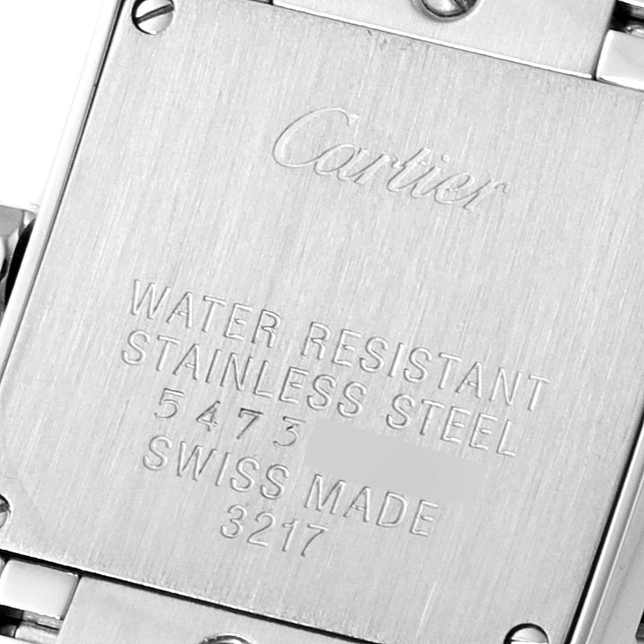 This image shows the back case of a Cartier Tank Française watch, indicating its stainless steel composition and water resistance.