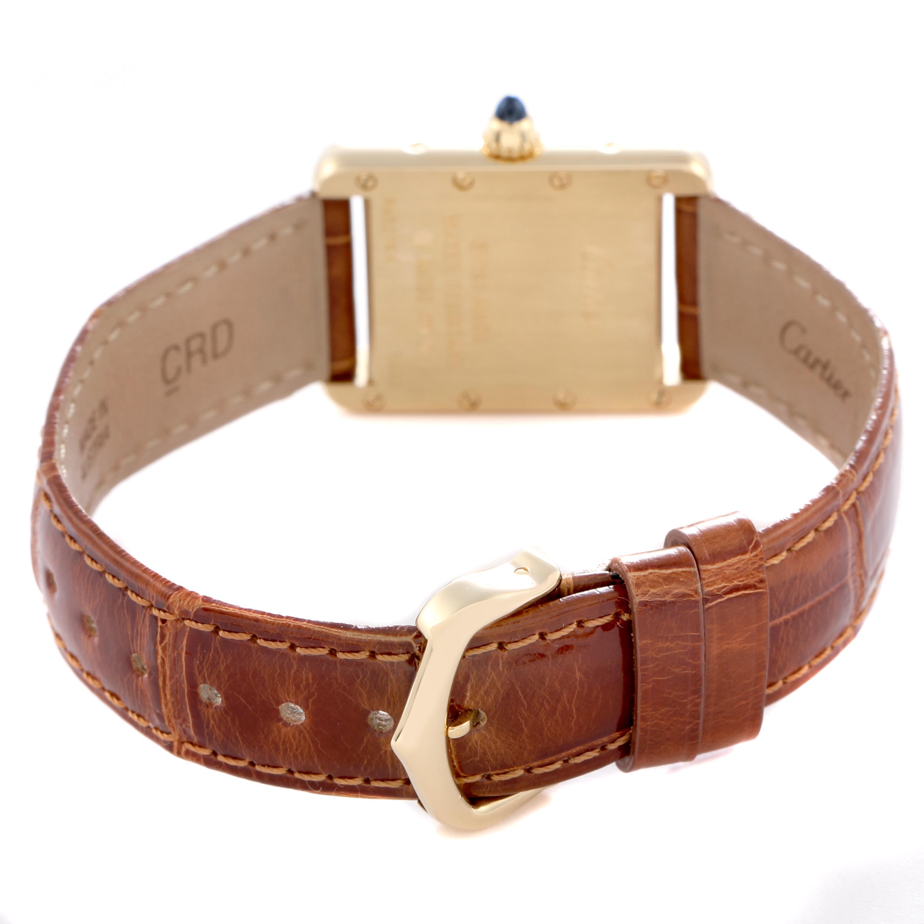 The Cartier Tank Louis W1529856 Women's Yellow Gold Silver Dial W1529856 Women's Yellow Gold Silver Dial watch is shown from the back, highlighting its gold case, brown leather strap, and clasp.