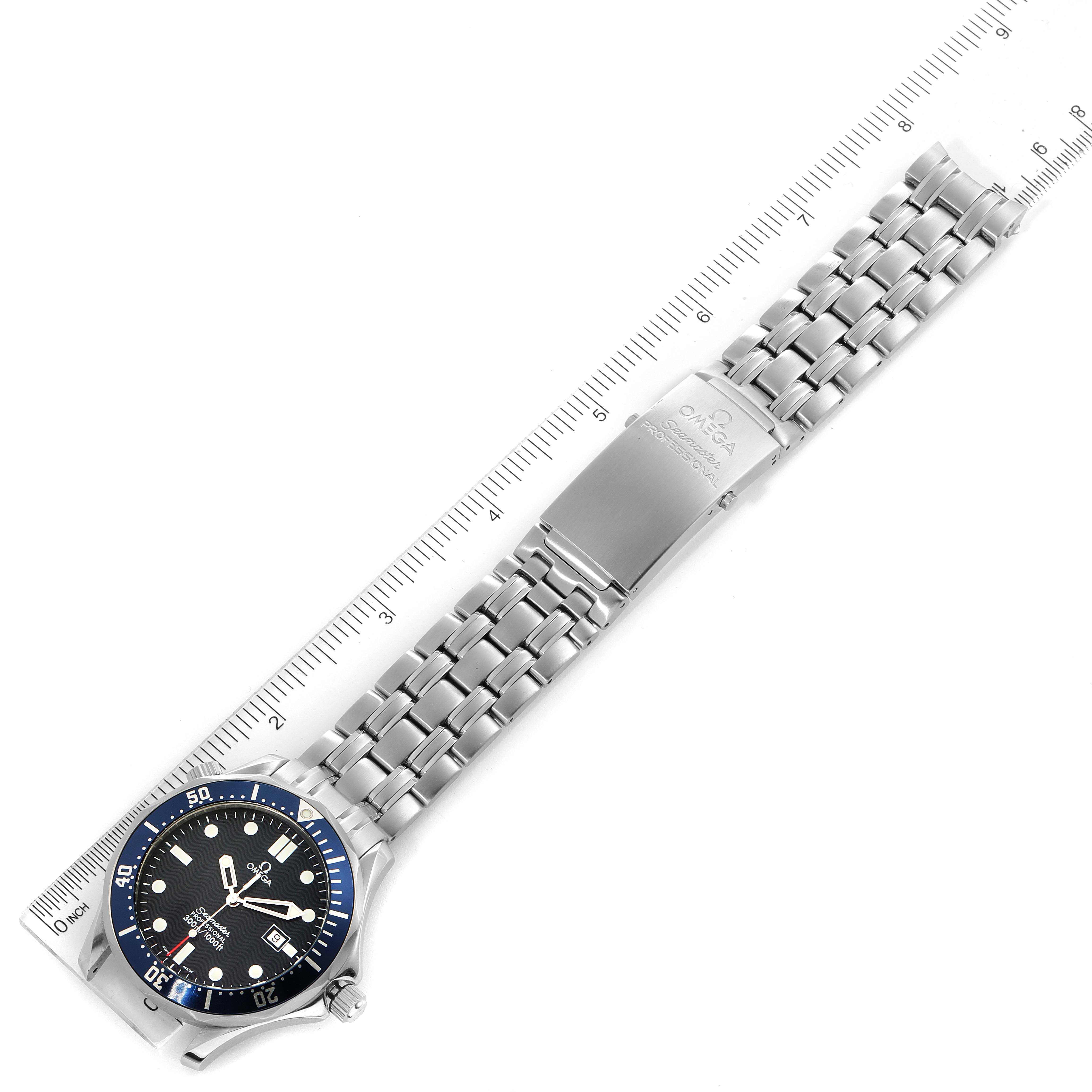 The image shows an Omega Seamaster 2541.80.00 Men
s Stainless Steel Blue Dial 2541.80.00 Men
s Stainless Steel Blue Dial watch displayed flat with a ruler for scale, highlighting the band and face.