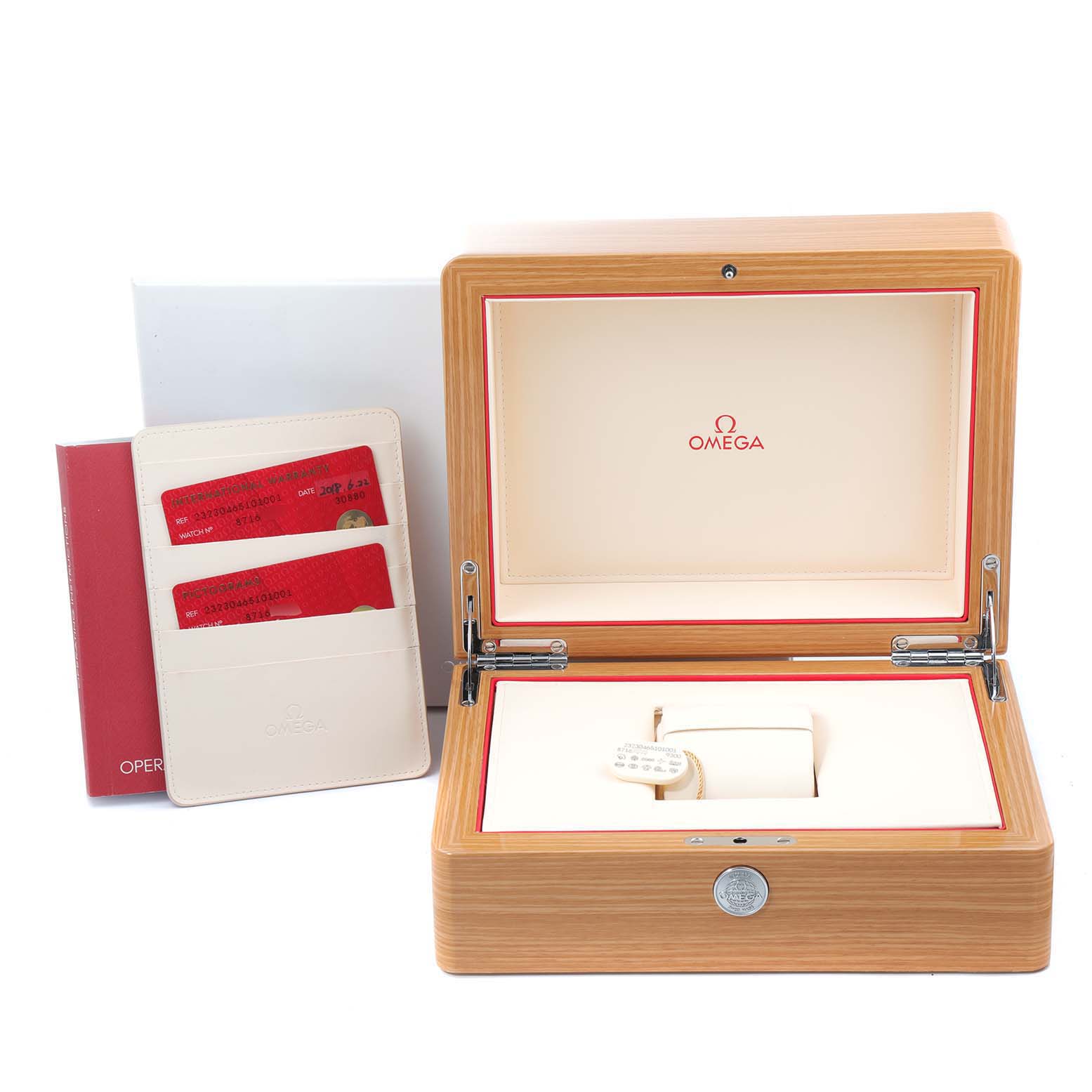 The image shows an open wooden Omega watch box for the Planet Ocean model and accompanying documents and cards.