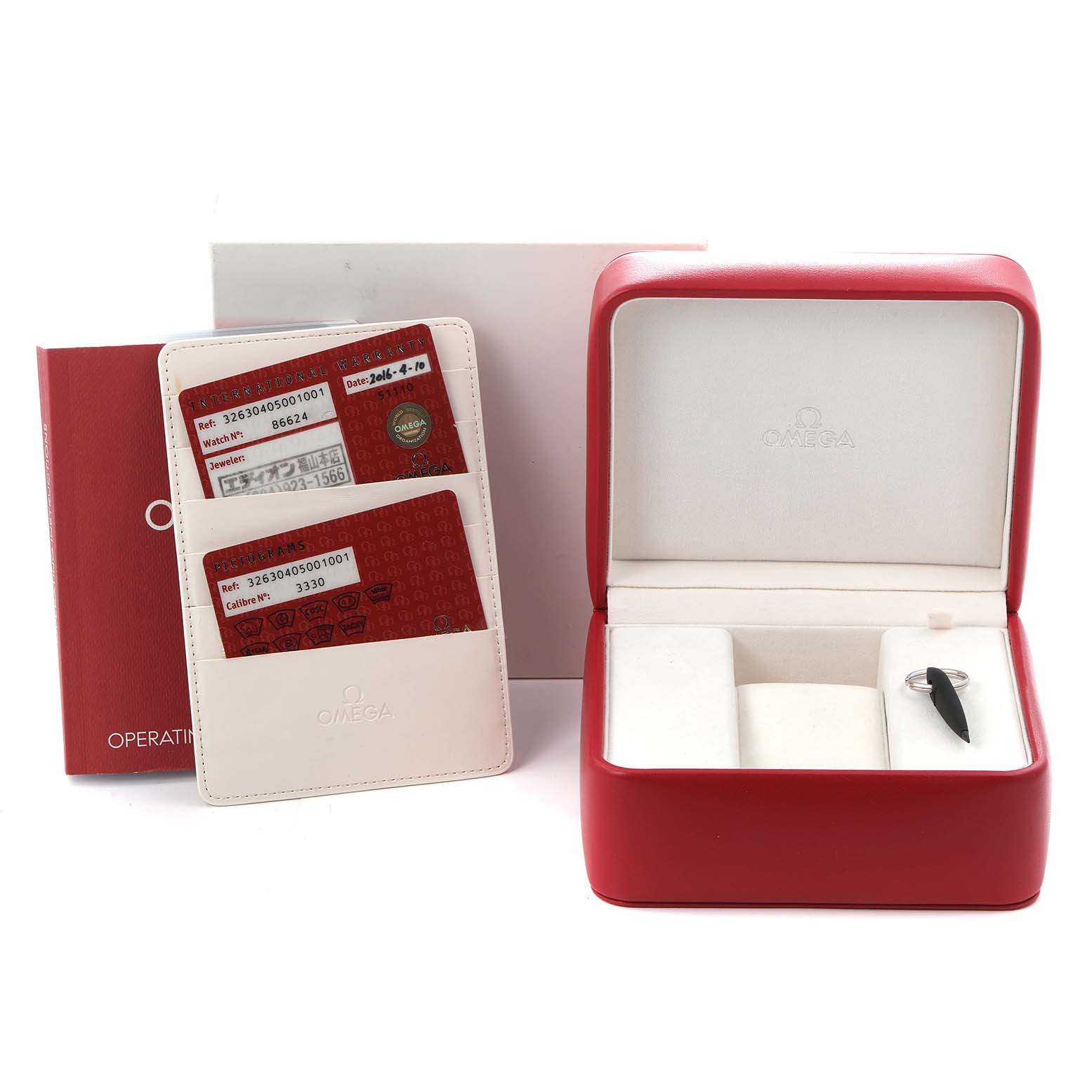 The image shows Omega's Speedmaster accessories, including a red box, manuals, and cards, with the main watch missing.
