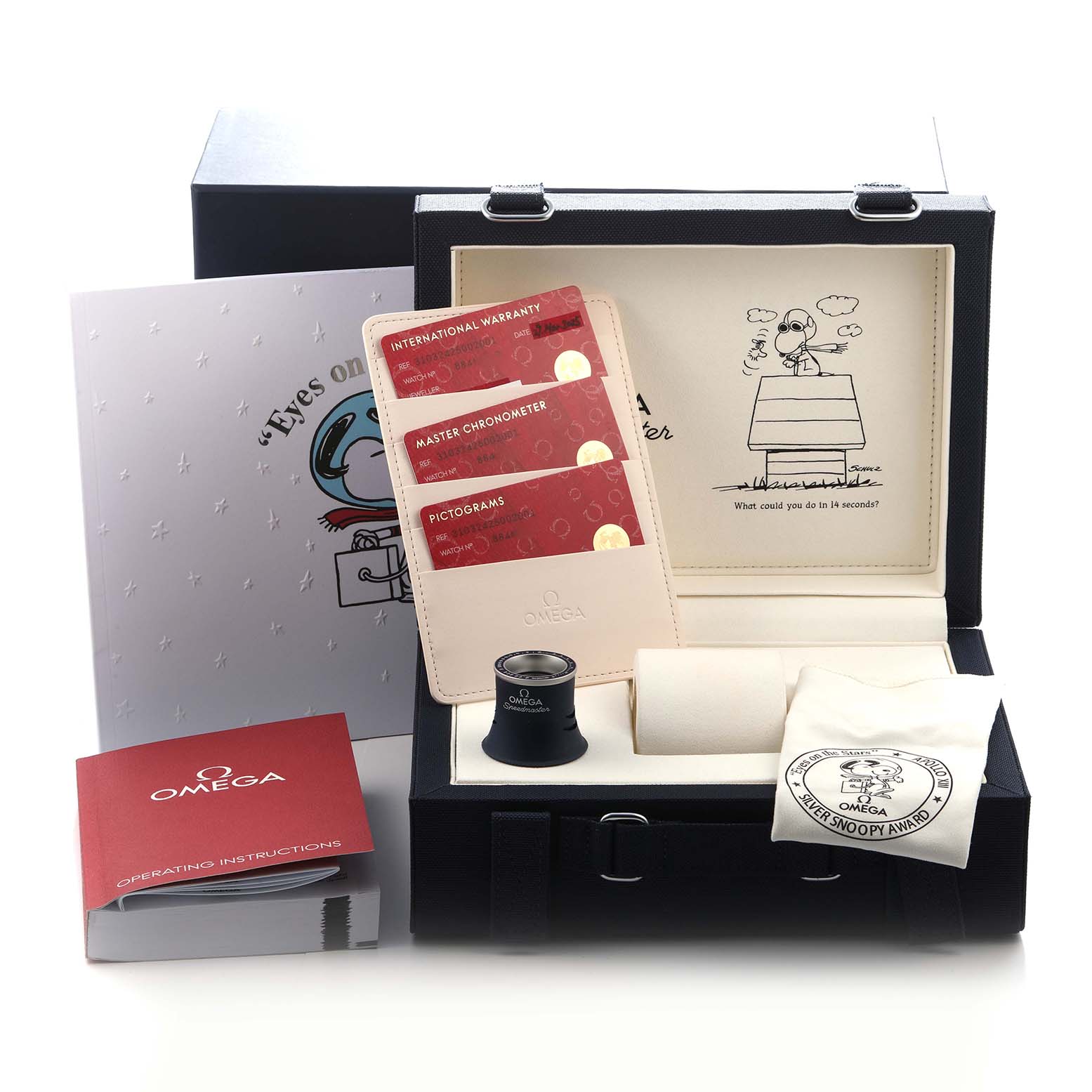 This image shows an Omega Speedmaster 310.32.42.50.02.001 Men's Stainless Steel Silver Dial 310.32.42.50.02.001 Men's Stainless Steel Silver Dial watch set with accessories, including warranty cards, a loupe, and packaging.