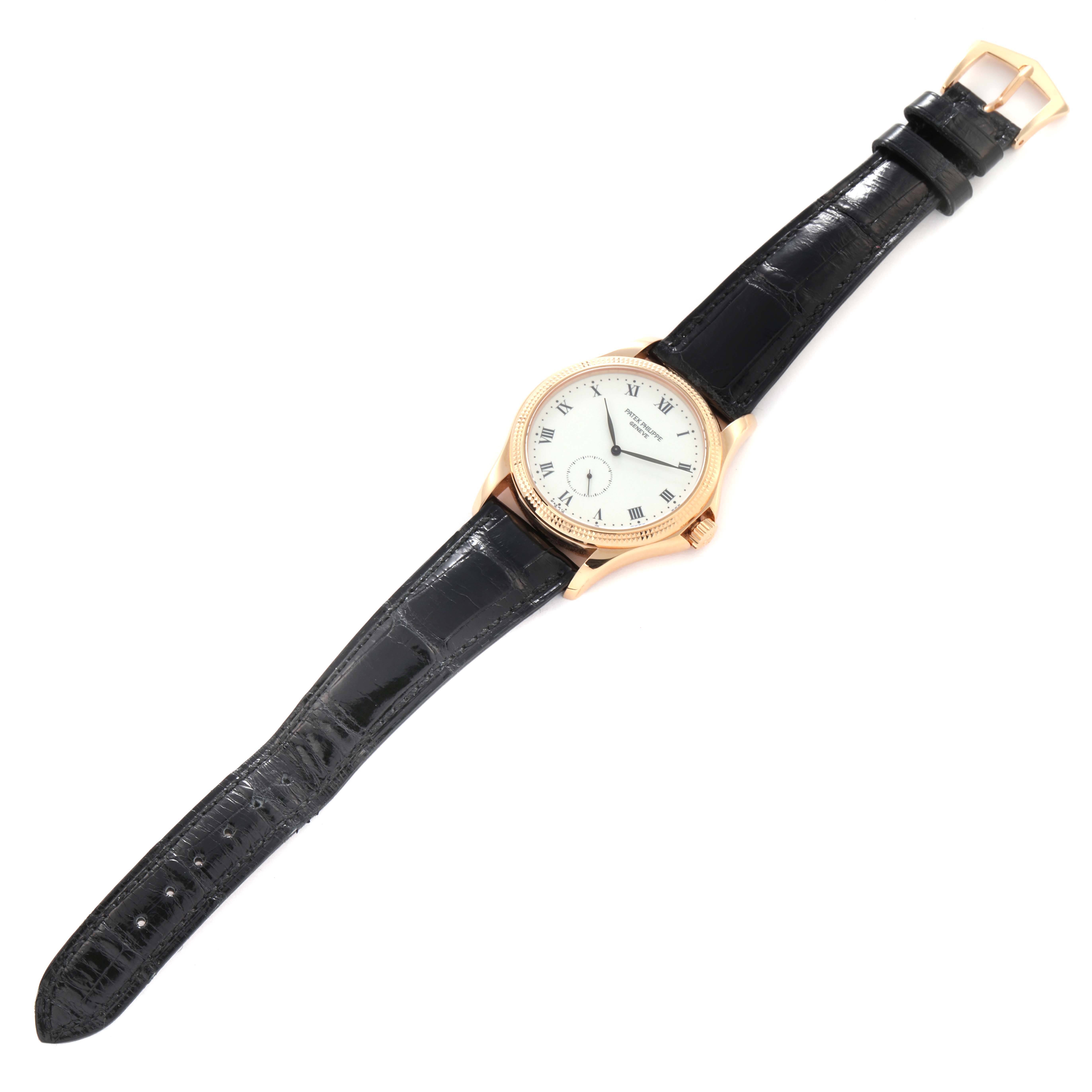 The Patek Philippe Calatrava 5115R-001 Men's Rose Gold White Dial 5115R-001 Men's Rose Gold White Dial watch is shown at a slight overhead angle, displaying the face, case, black leather strap, and buckle.