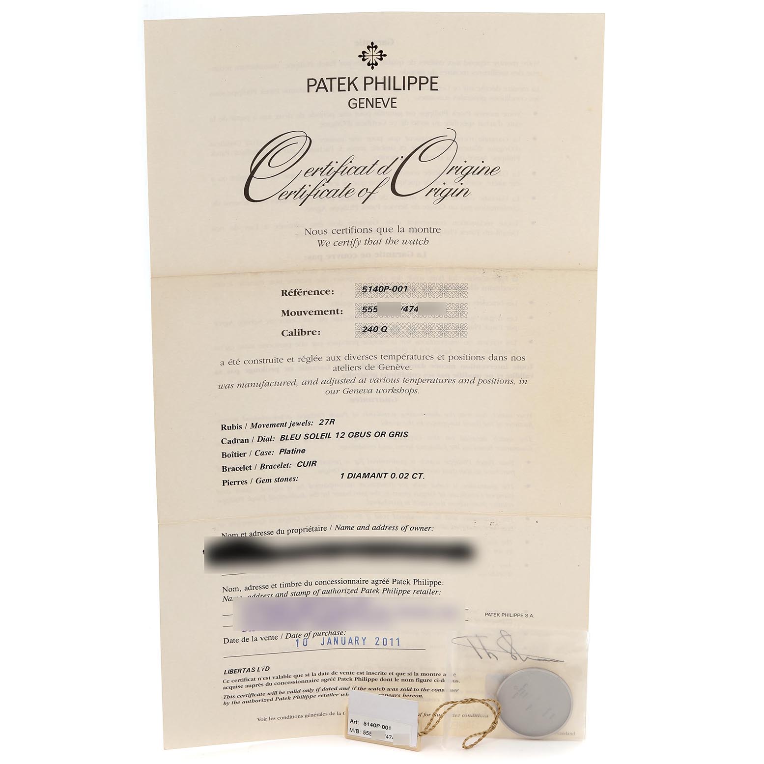 The image shows a certificate of origin for a Patek Philippe Complications 5140P-001 Men's Platinum Blue Dial 5140P-001 Men's Platinum Blue Dial model, displayed flat with a sealed tag beside it.