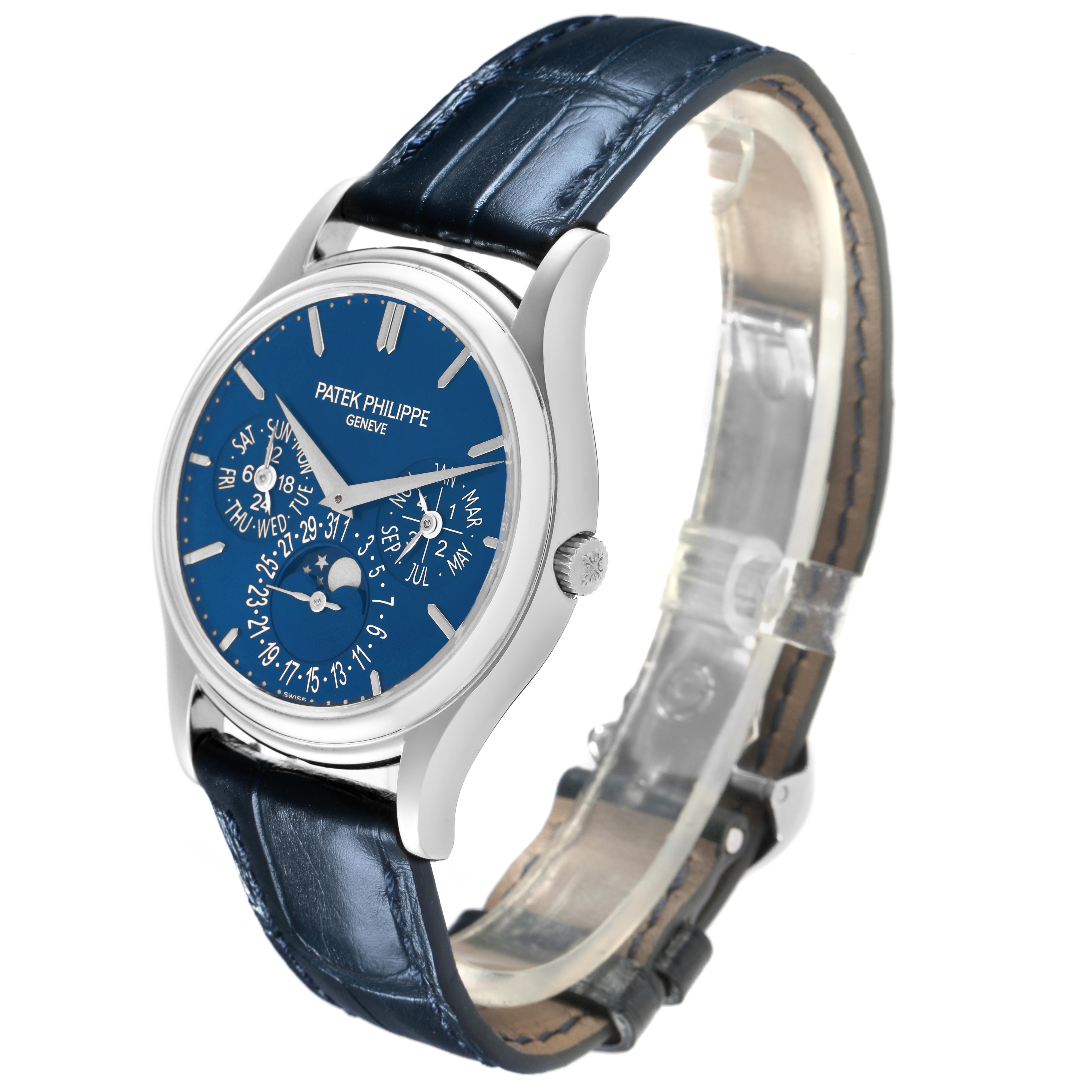 The Patek Philippe Complications 5140P-001 Men's Platinum Blue Dial 5140P-001 Men's Platinum Blue Dial watch is shown at a three-quarter angle, displaying its blue dial, leather strap, and side crown.
