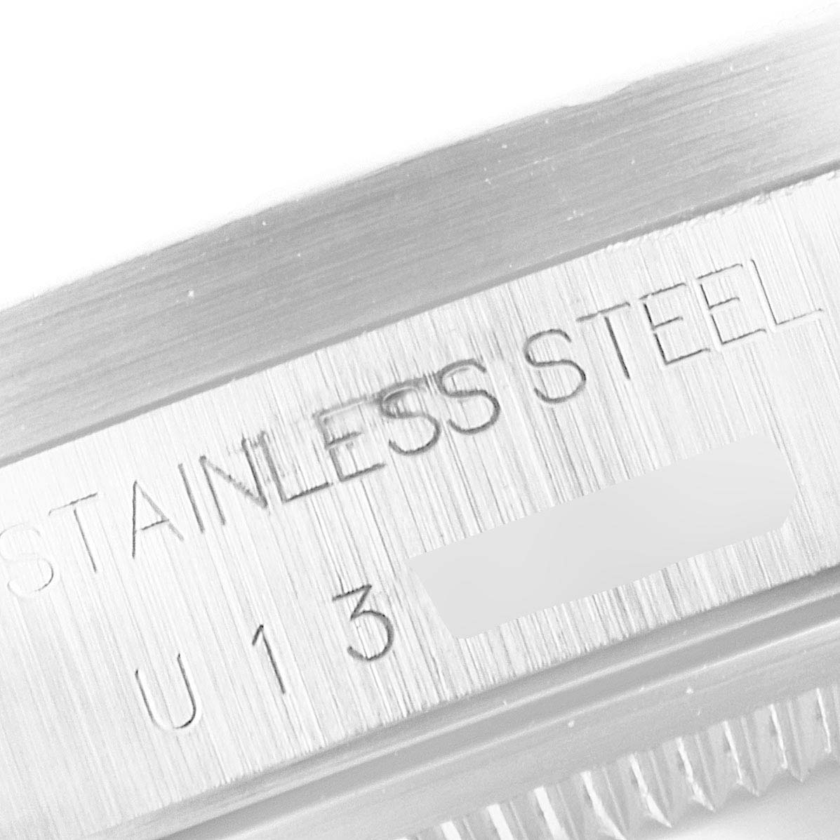 This close-up image shows the stainless steel engraving on the bezel of a Rolex Air-King 14010 Men's Stainless Steel Blue Dial 14010 Men's Stainless Steel Blue Dial watch.