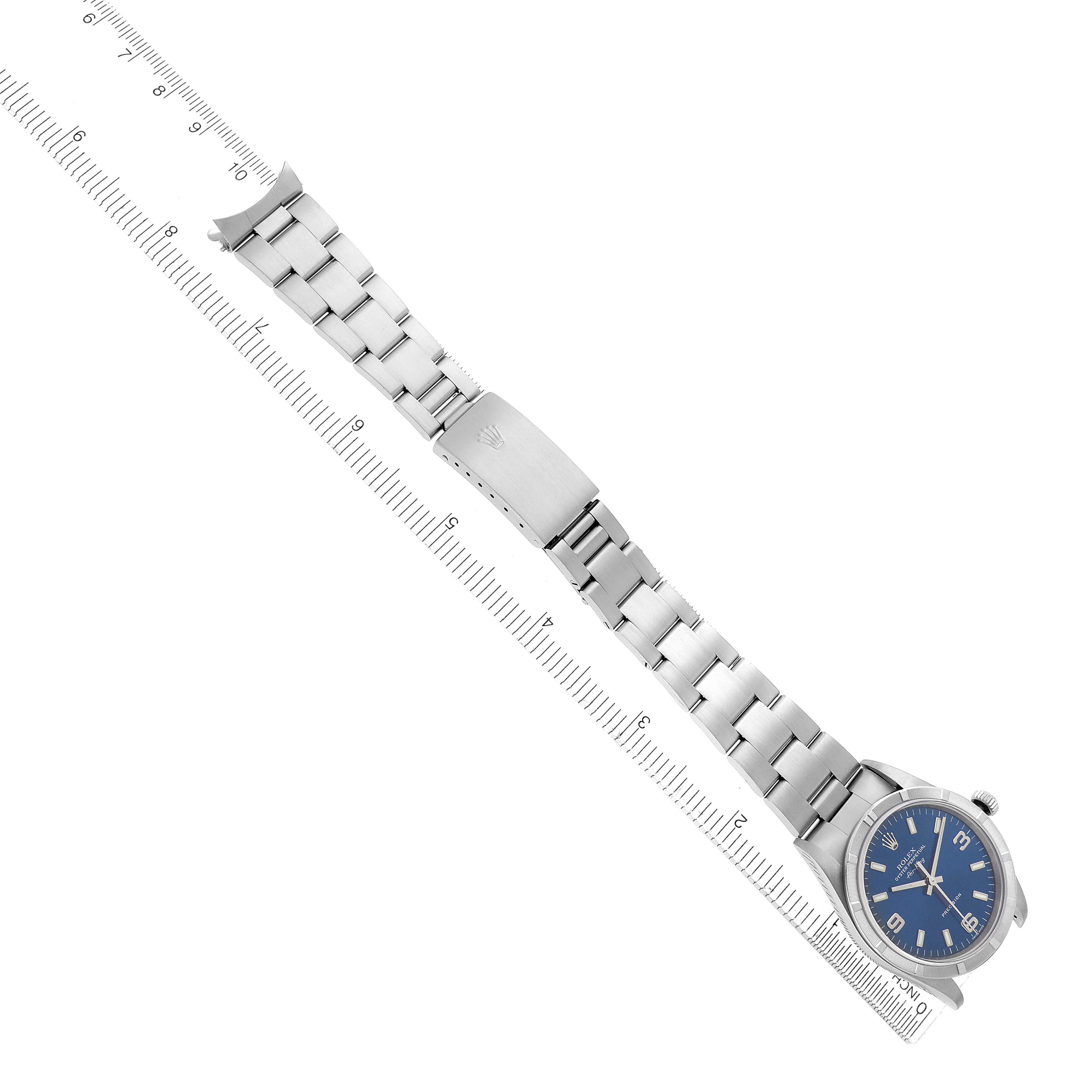 The Rolex Air-King 14010 Men's Stainless Steel Blue Dial 14010 Men's Stainless Steel Blue Dial is shown from a top-down angle, featuring its full bracelet and clasp alongside a ruler.