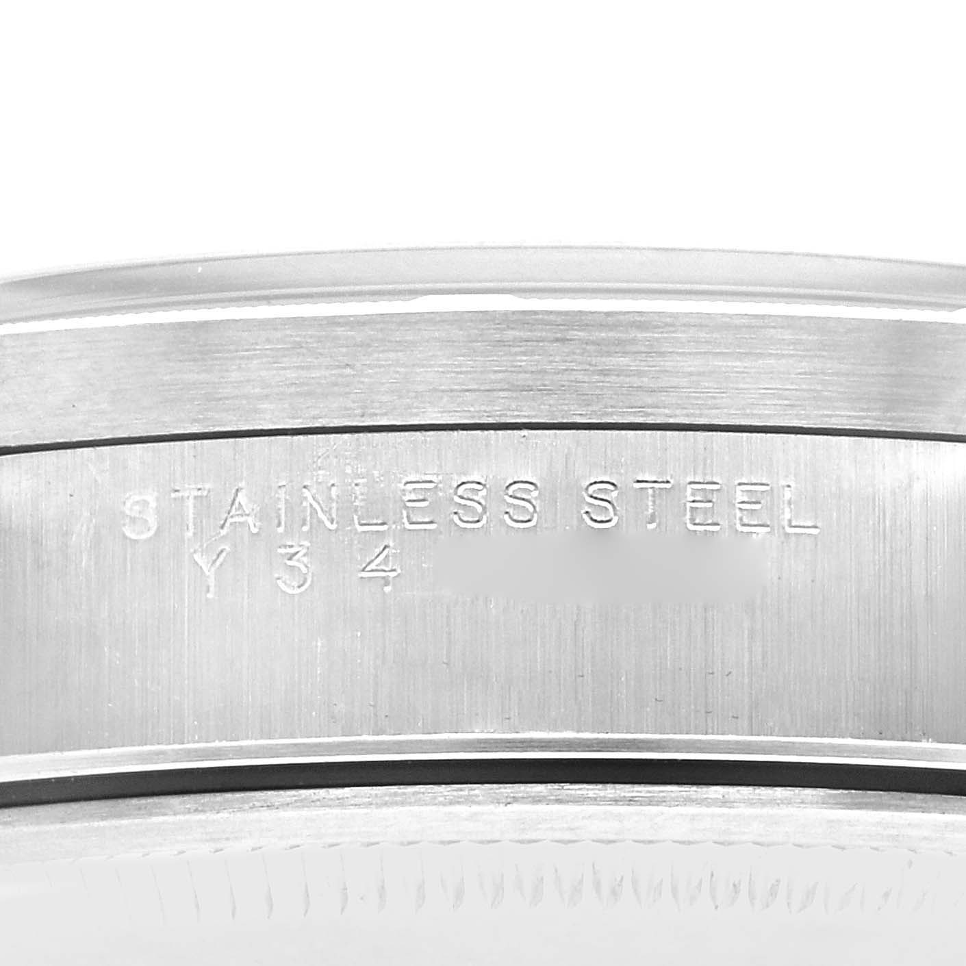 The image shows the side of the stainless steel casing of a Rolex Air-King 14010 Men's Stainless Steel Blue Dial 14010 Men's Stainless Steel Blue Dial watch, highlighting engraved text.