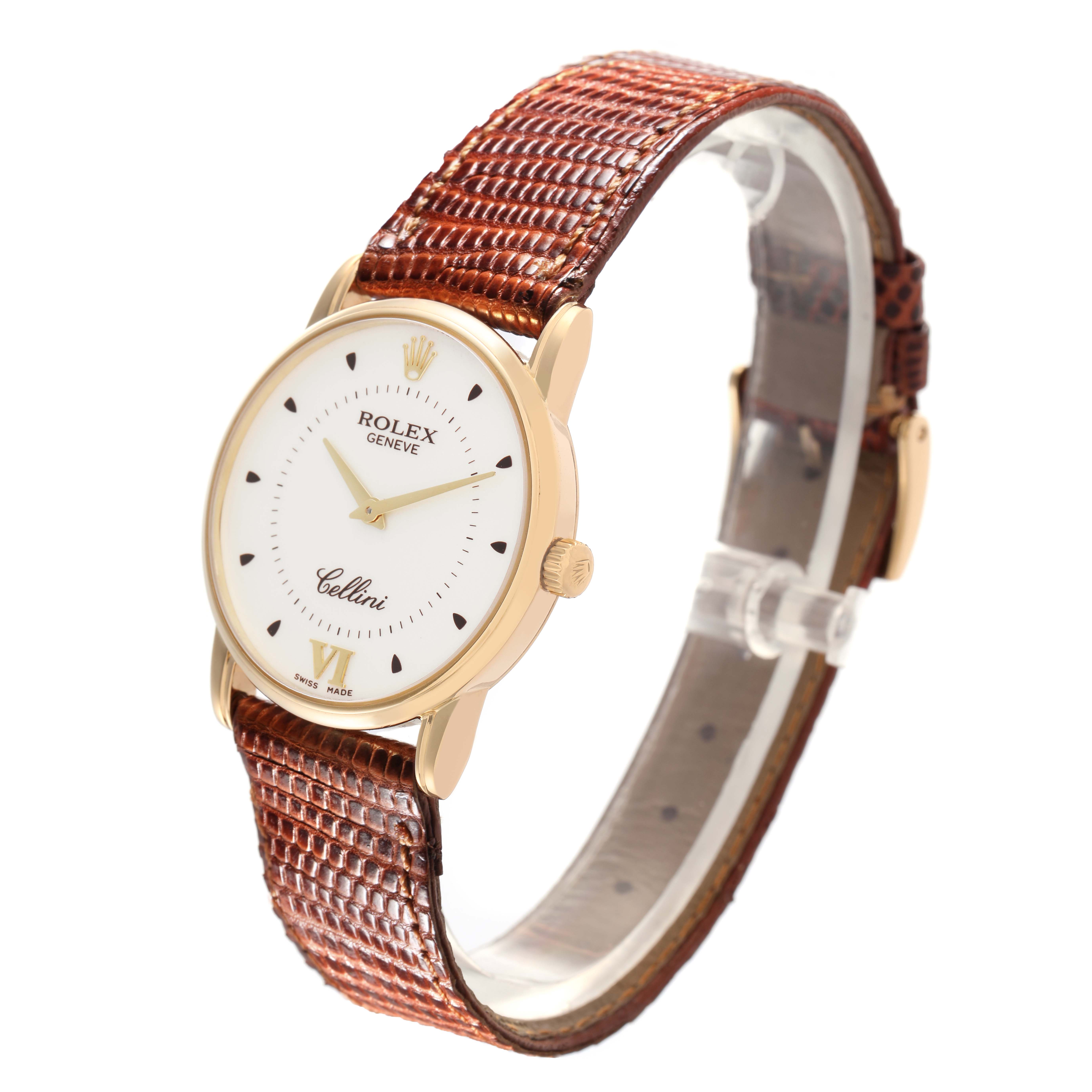 The Rolex Cellini 5116/8 Men's Yellow Gold Silver Dial 5116/8 Men's Yellow Gold Silver Dial watch is shown at an angled side view with a focus on its gold case and textured brown leather strap.