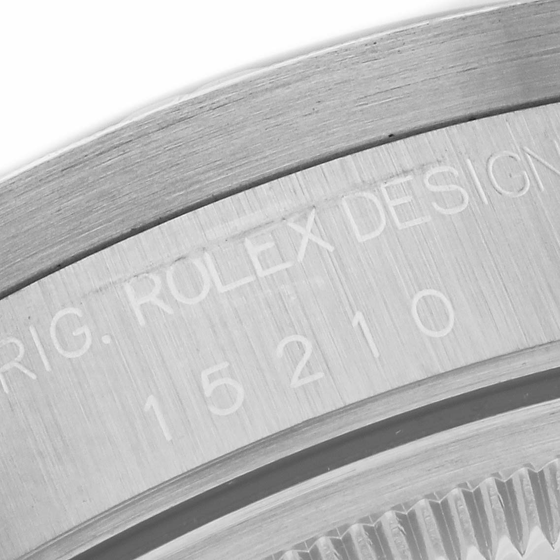 This image shows a close-up of the case back and serial number of a Rolex Date 15210 Men's Stainless Steel Blue Dial 15210 Men's Stainless Steel Blue Dial model watch.