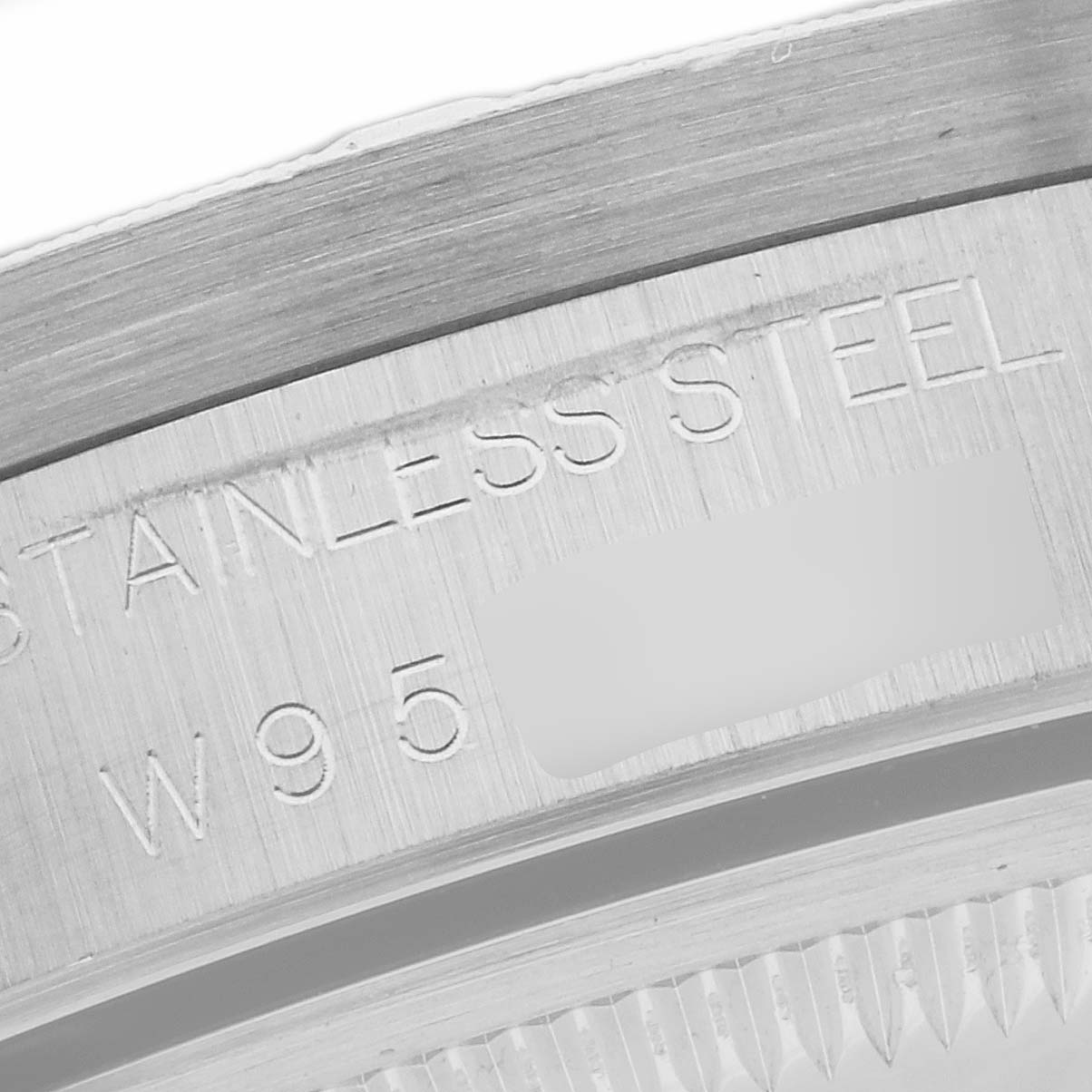 This close-up image shows the engraved text on the stainless steel case back of the Rolex Date 15210 Men's Stainless Steel Blue Dial 15210 Men's Stainless Steel Blue Dial watch model.