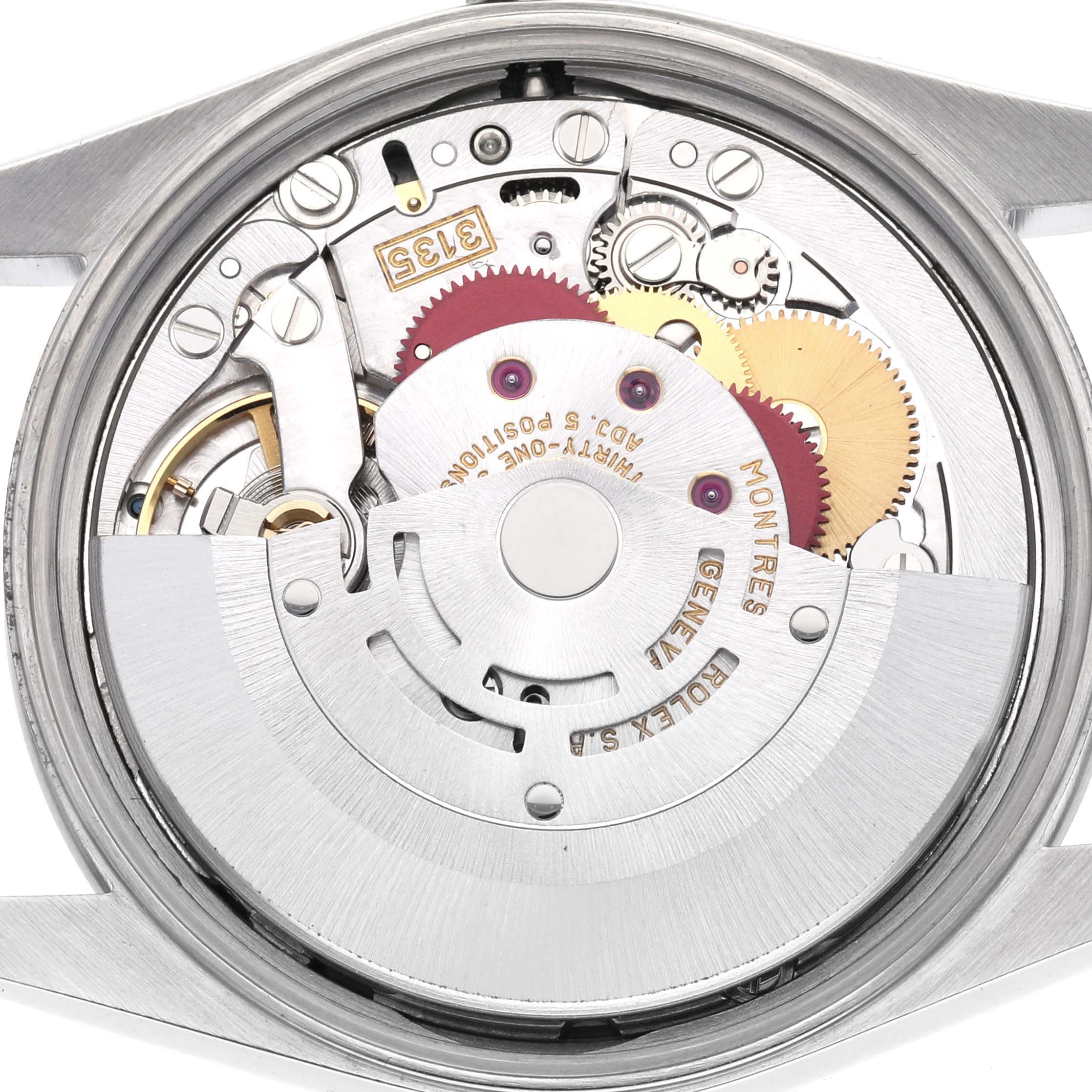 The image shows the Rolex Date 15200 Men's Stainless Steel Pink Dial 15200 Men's Stainless Steel Pink Dial model's movement from a top-down angle, featuring gears and inscriptions.