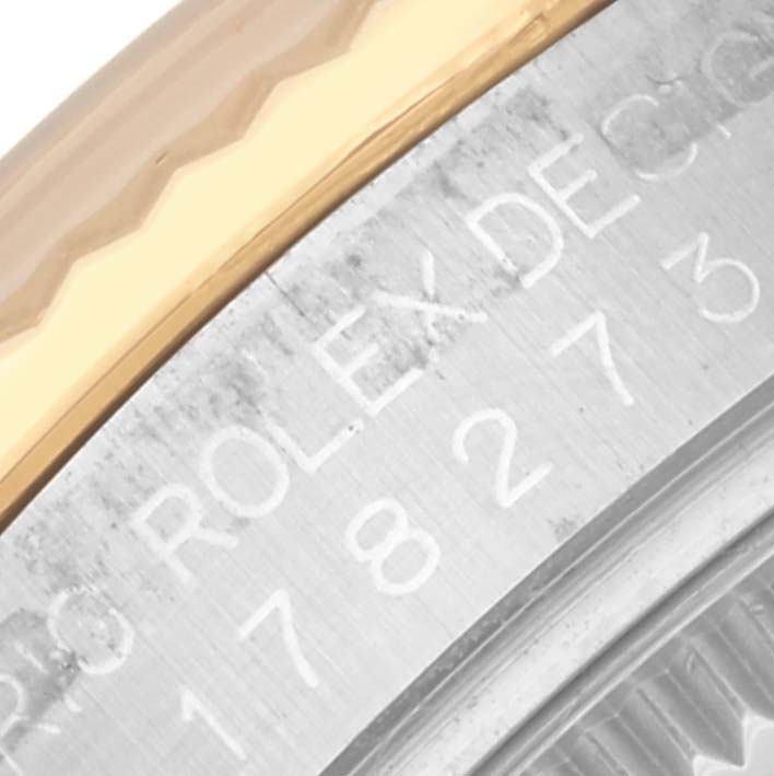This image shows a close-up view of the side of a mid-size Rolex watch, focusing on the engraved reference number and bezel.