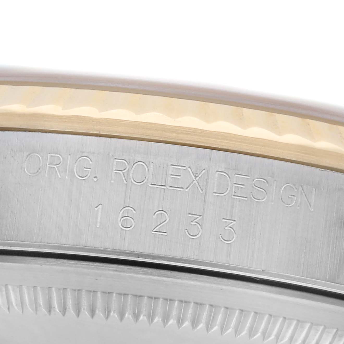 The image shows the side engraving of the Rolex Datejust 16233 Men's Steel and Gold (two tone) Champagne Dial 16233 Men's Steel and Gold (two tone) Champagne Dial model 16233, highlighting the model number and design inscriptions.