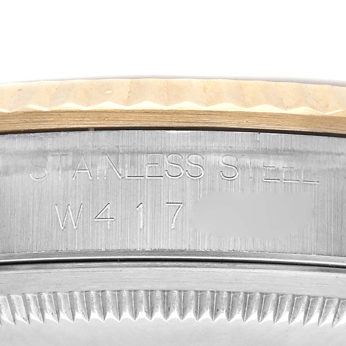 The image shows a close-up of the side engraving on a Rolex Datejust 16233 Men's Steel and Gold (two tone) Champagne Dial 16233 Men's Steel and Gold (two tone) Champagne Dial, revealing "STAINLESS STEEL" and a serial or model number.