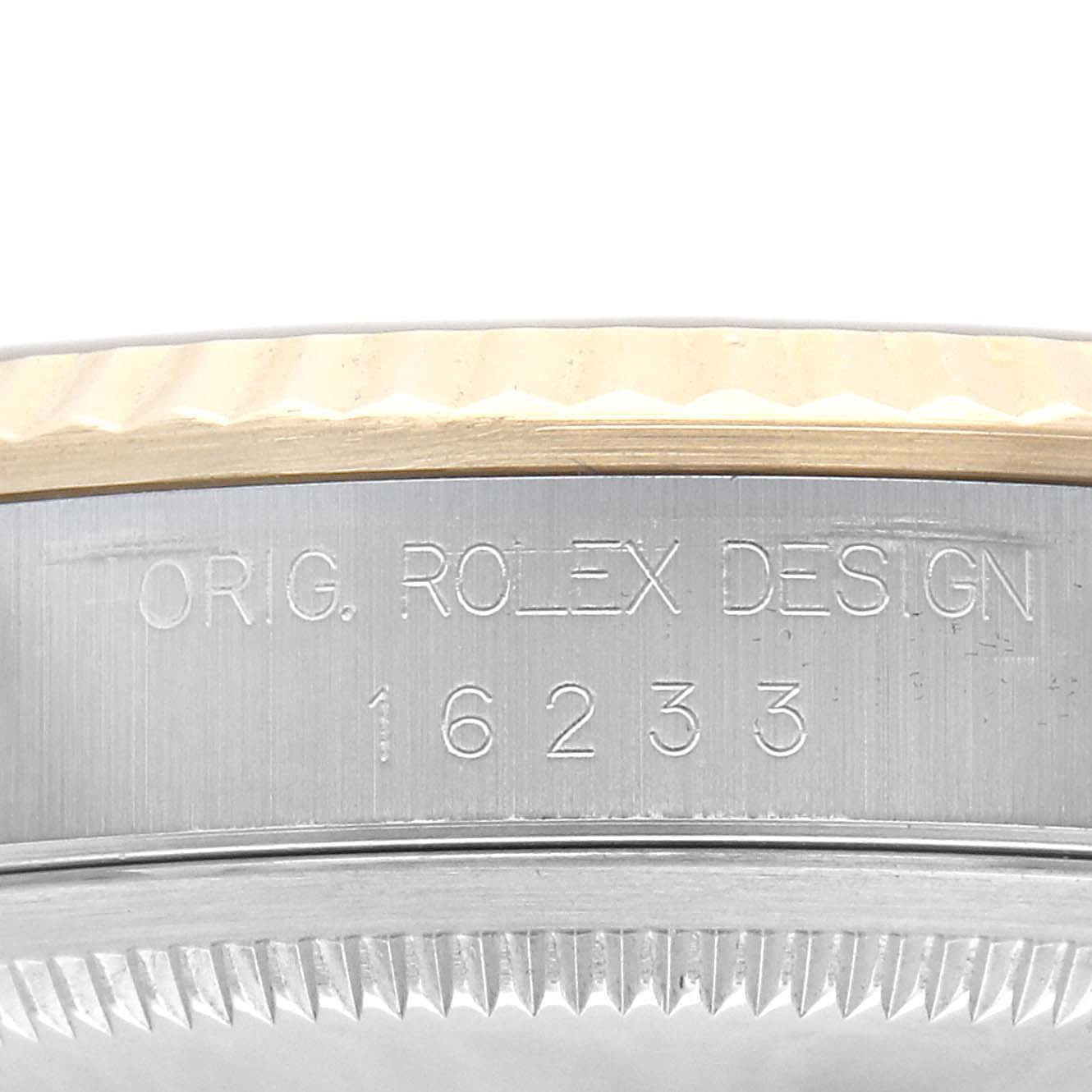The image shows the side view of a Rolex Datejust 16233 Men's Steel and Gold (two tone) Champagne Dial 16233 Men's Steel and Gold (two tone) Champagne Dial watch, focusing on the engraved model number and bezel.