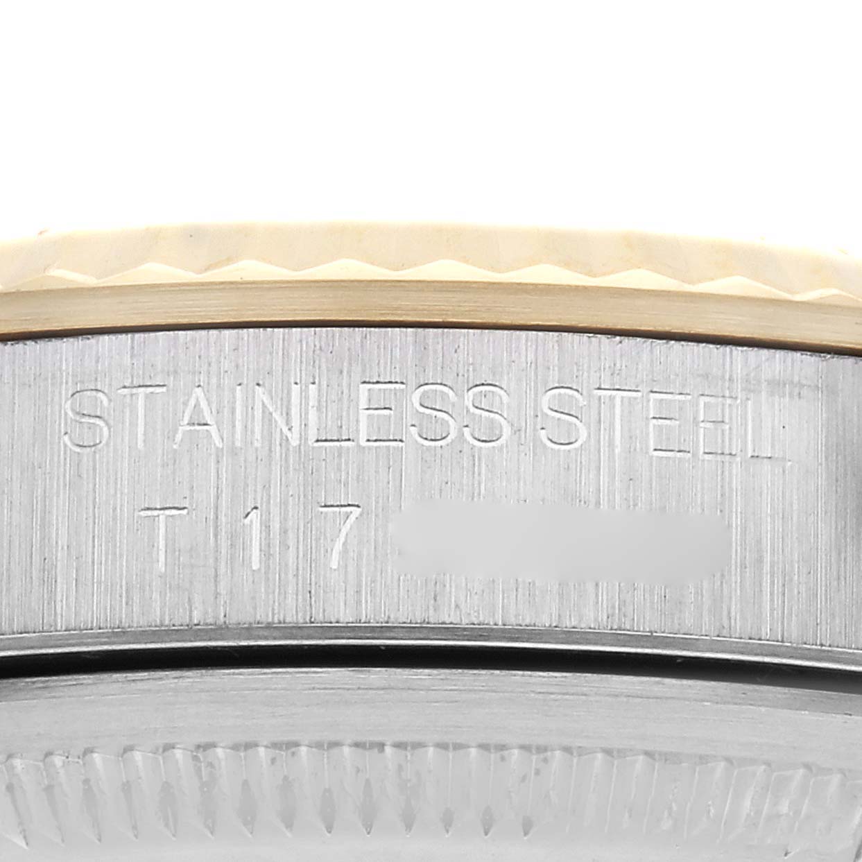 The image shows a close-up of the side of a Rolex Datejust 16233 Men's Steel and Gold (two tone) Champagne Dial 16233 Men's Steel and Gold (two tone) Champagne Dial, highlighting the stainless steel casing and some engraved details.