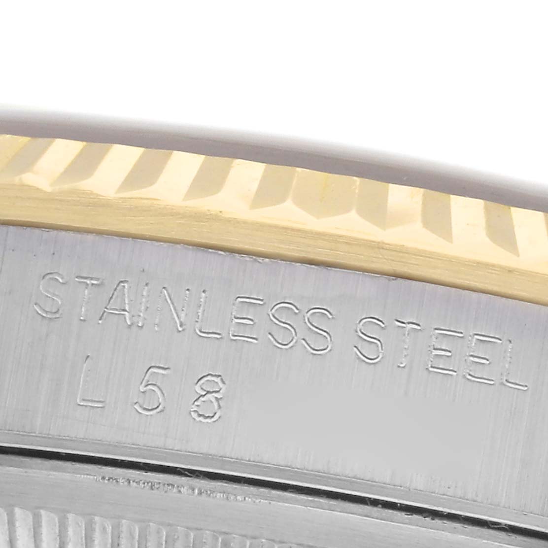 The image shows a close-up of the Datejust by Rolex, highlighting the fluted bezel and engraved stainless steel part.
