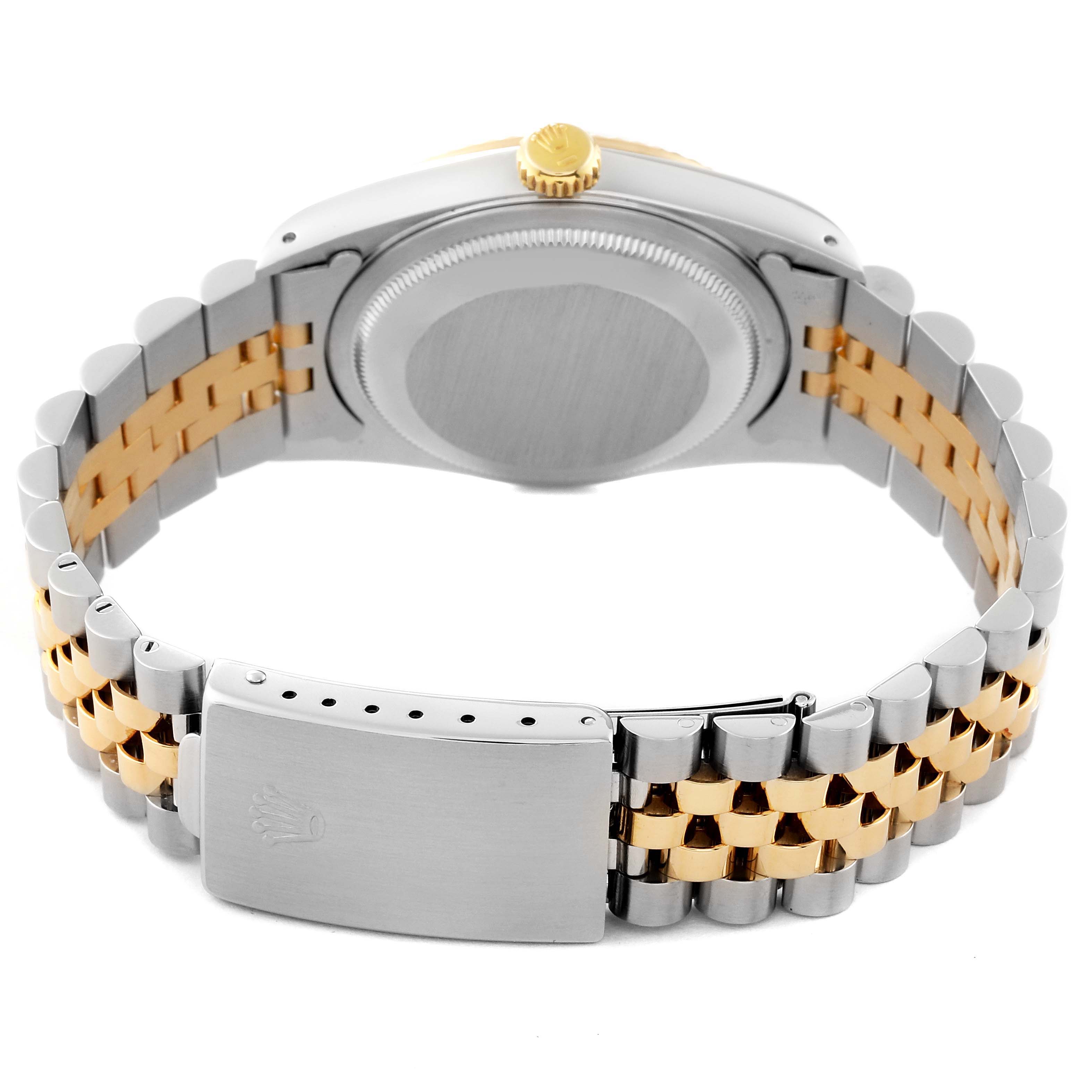 The image shows the back view of a Rolex Datejust 16233 Men
s Steel and Gold (two tone) Silver Dial 16233 Men
s Steel and Gold (two tone) Silver Dial watch, highlighting the case, crown, and two-tone bracelet with its clasp.