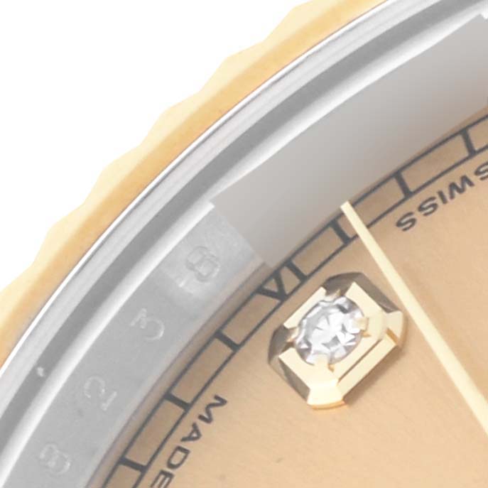 This close-up image shows a partial view of the dial, diamond hour marker, and fluted bezel of a Rolex Datejust 41 116333 Men's Steel and Gold (two tone) Champagne Dial 116333 Men's Steel and Gold (two tone) Champagne Dial watch.