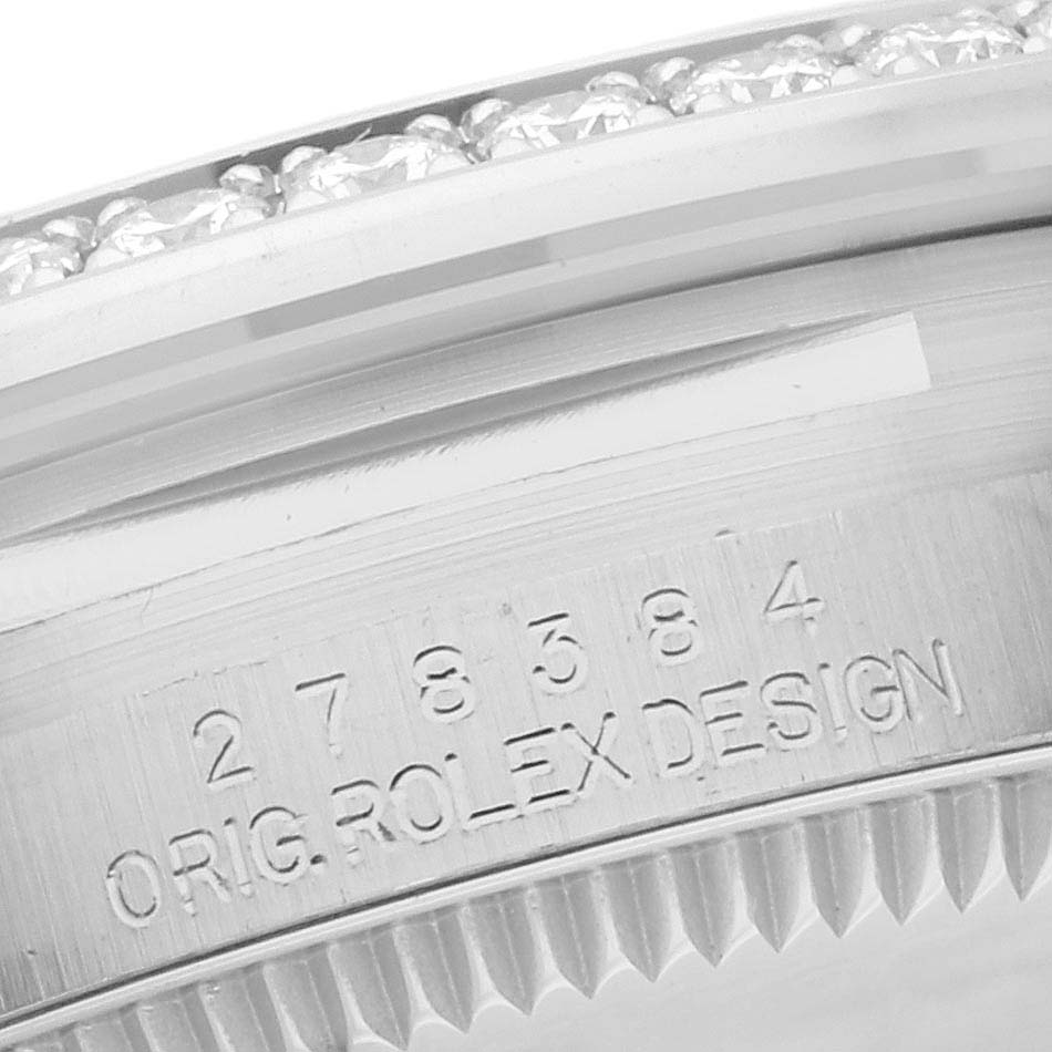 The image shows a close-up of the bezel and engraving on a Mid-Size Rolex watch.
