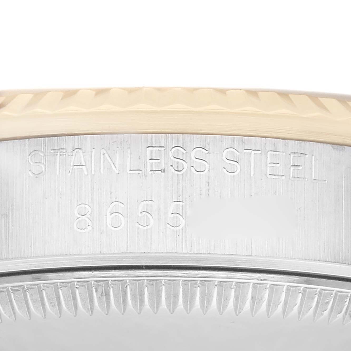 The image shows a close-up of the side of a Mid-Size Rolex watch case, focusing on the stainless steel engraving and part of the bezel.