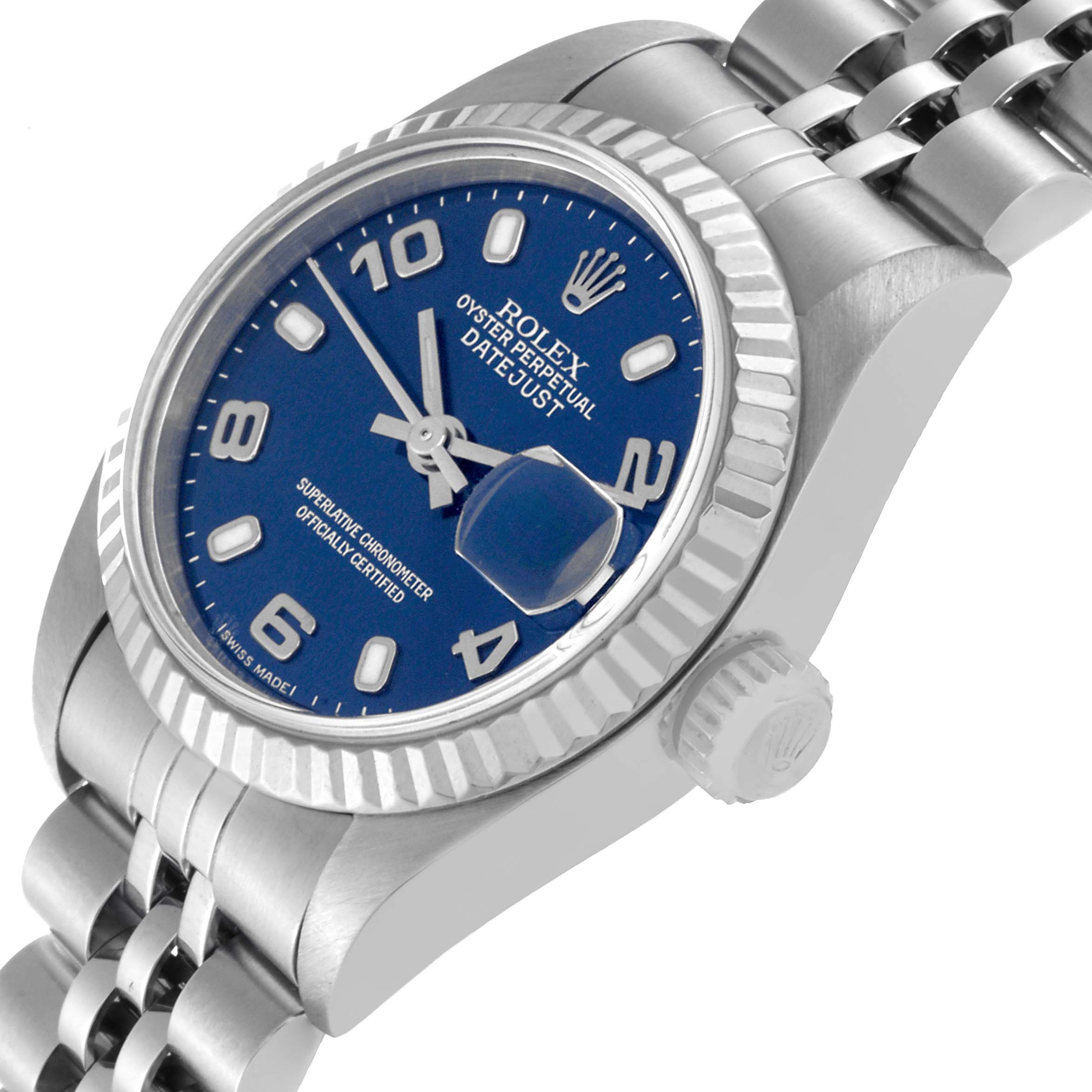 This image shows a side angle of the Rolex Datejust 79174 Women's Stainless Steel Blue Dial 79174 Women's Stainless Steel Blue Dial watch, highlighting its blue dial, fluted bezel, and crown.