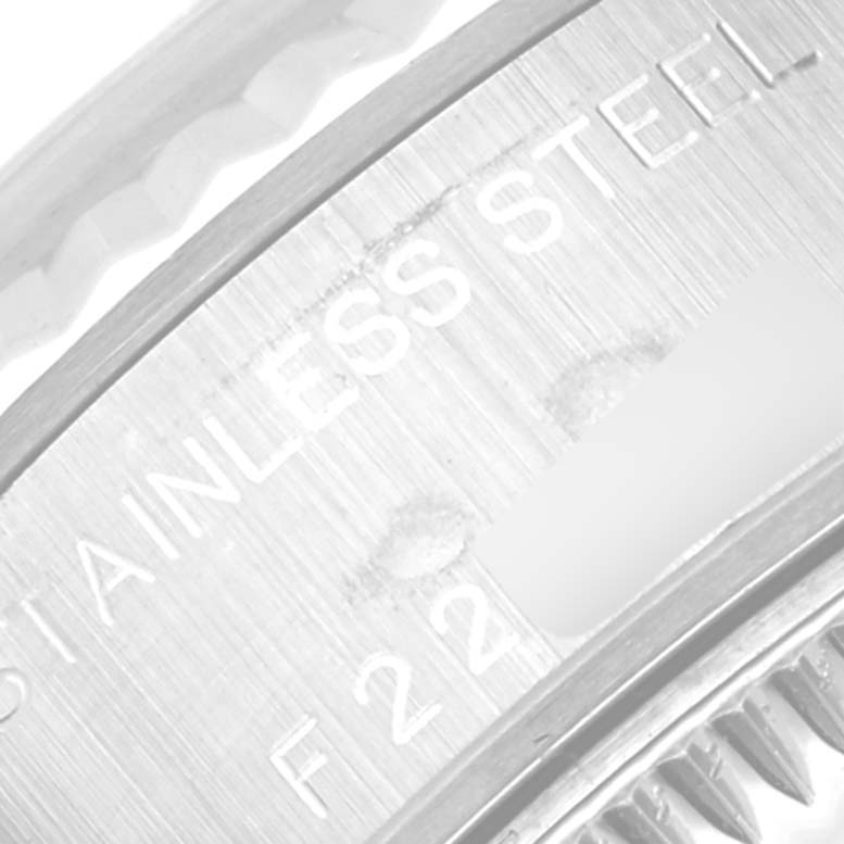 This close-up shows the engraved stainless steel marking on the back case of a Rolex Datejust 79174 Women's Stainless Steel Blue Dial 79174 Women's Stainless Steel Blue Dial watch.