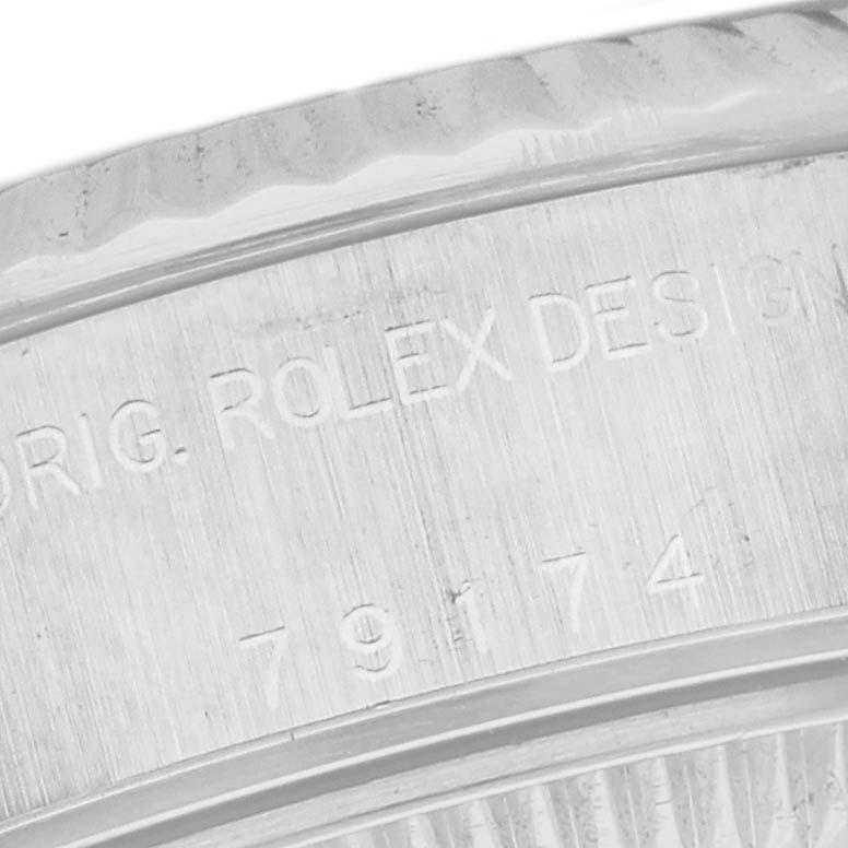 This image shows a close-up view of the engraved case side of a Rolex Datejust 79174 Women's Stainless Steel Pink Dial 79174 Women's Stainless Steel Pink Dial model, highlighting the text "ORIG. ROLEX DESIGN."