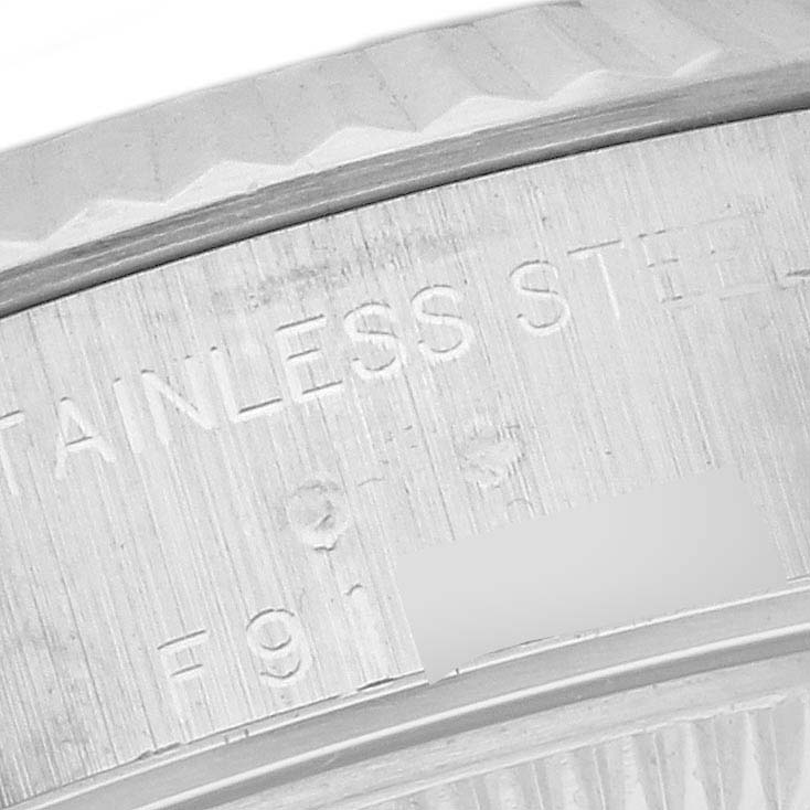 This image shows a close-up of the side profile of the bezel and rehaut with engraved markings of a Rolex Datejust 79174 Women's Stainless Steel Pink Dial 79174 Women's Stainless Steel Pink Dial watch.
