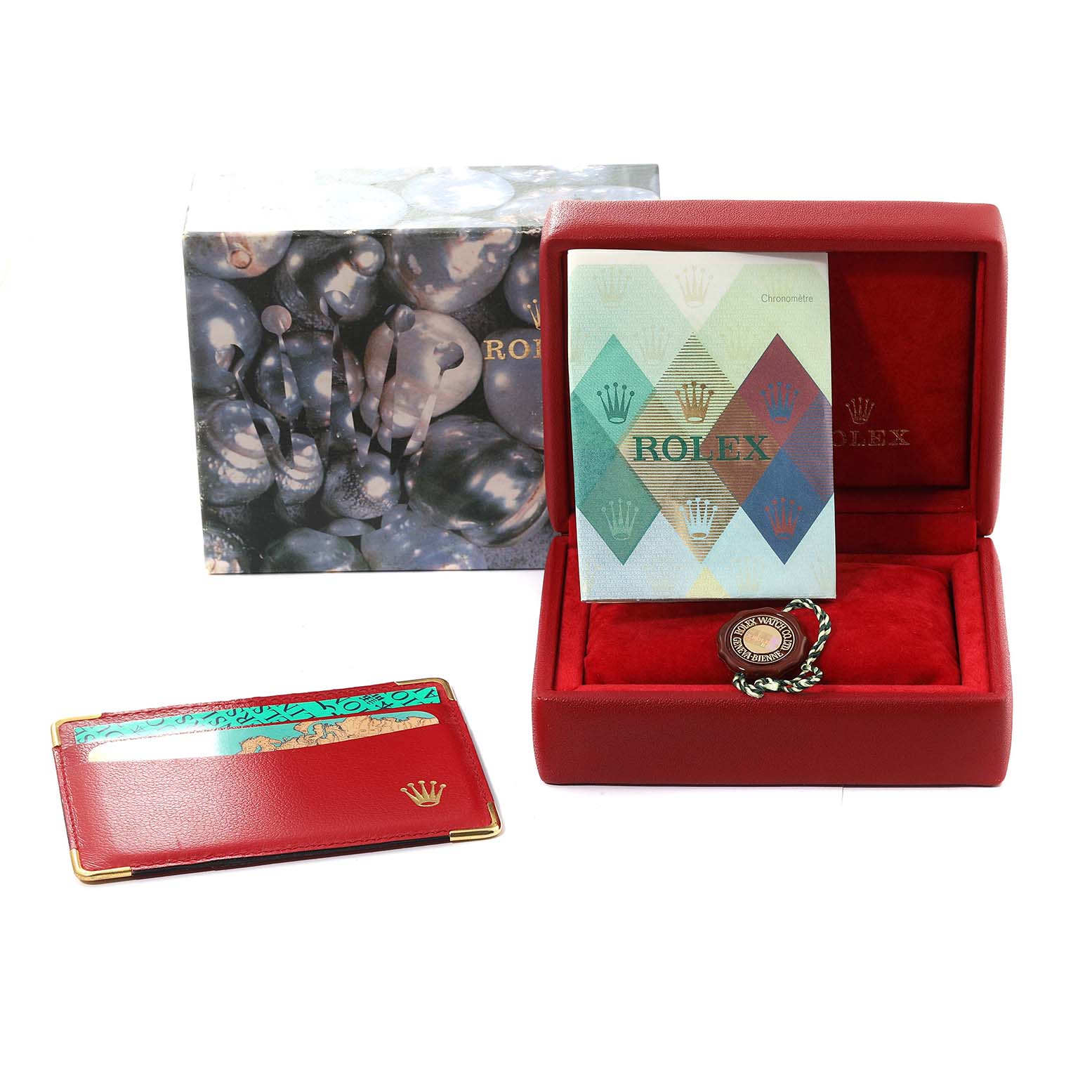 The image shows a Rolex Datejust 79174 Women's Stainless Steel Pink Dial 79174 Women's Stainless Steel Pink Dial watch box set, including a red case, manuals, a cardholder, and a seal.