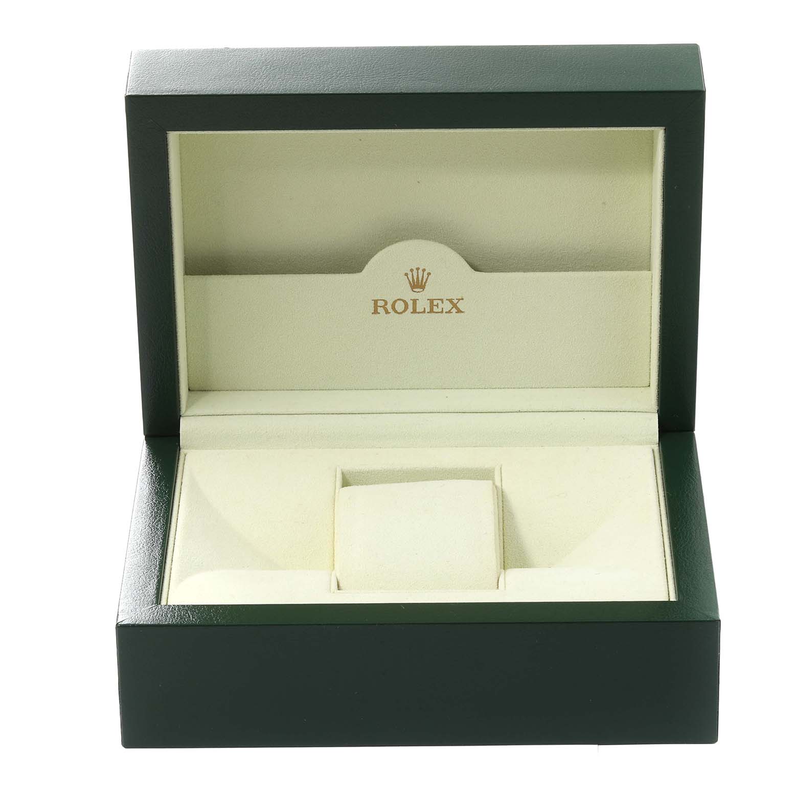 The image shows an open green and beige Rolex watch box, typically used for the Datejust model.